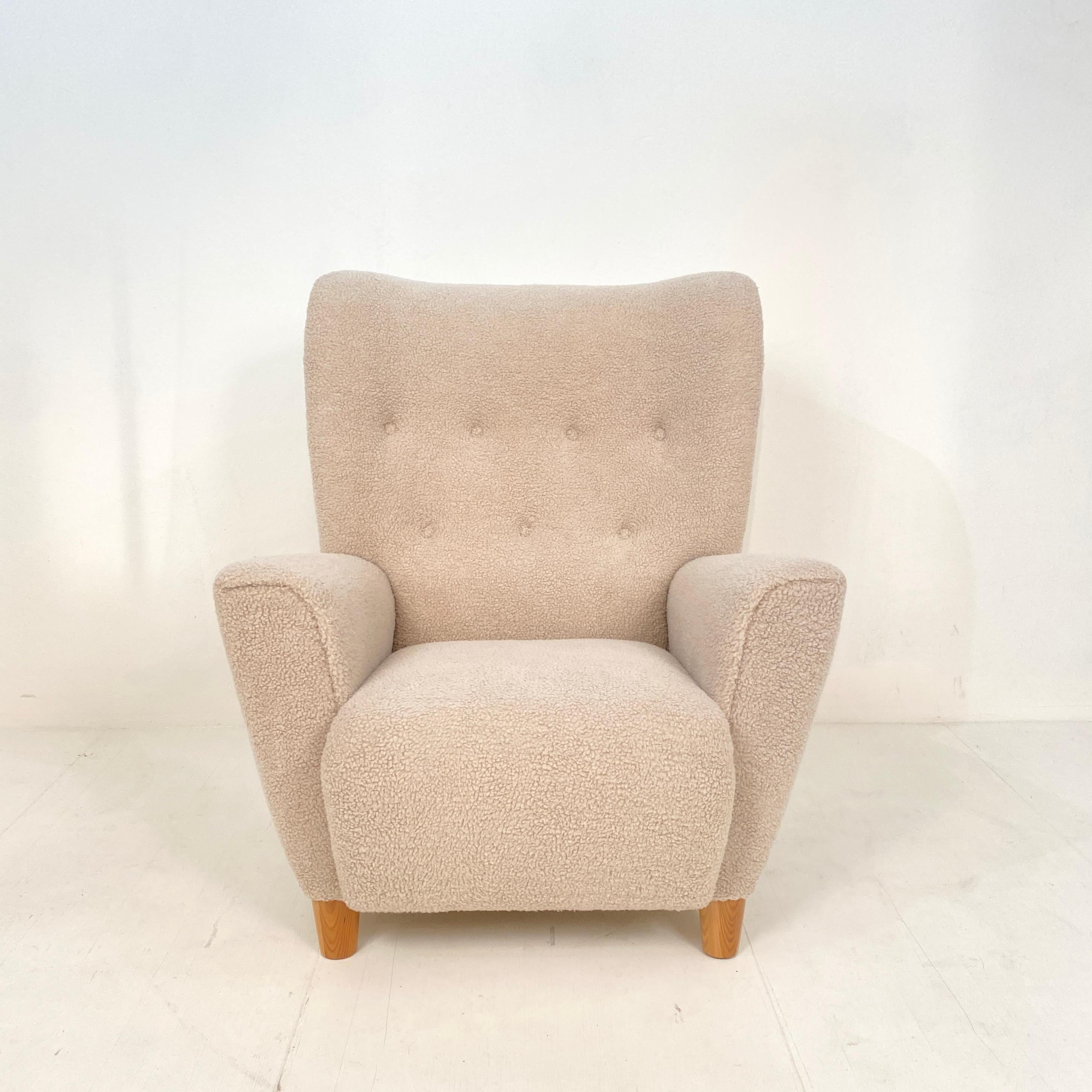 This beautiful mid century Danish high back wing chair or armchair was made around 1970.
It is the style of Flemming Lassen.
It was recently re-upholstered in a light beige shearling fabric. The chair is very comfortable and in great condition.
A