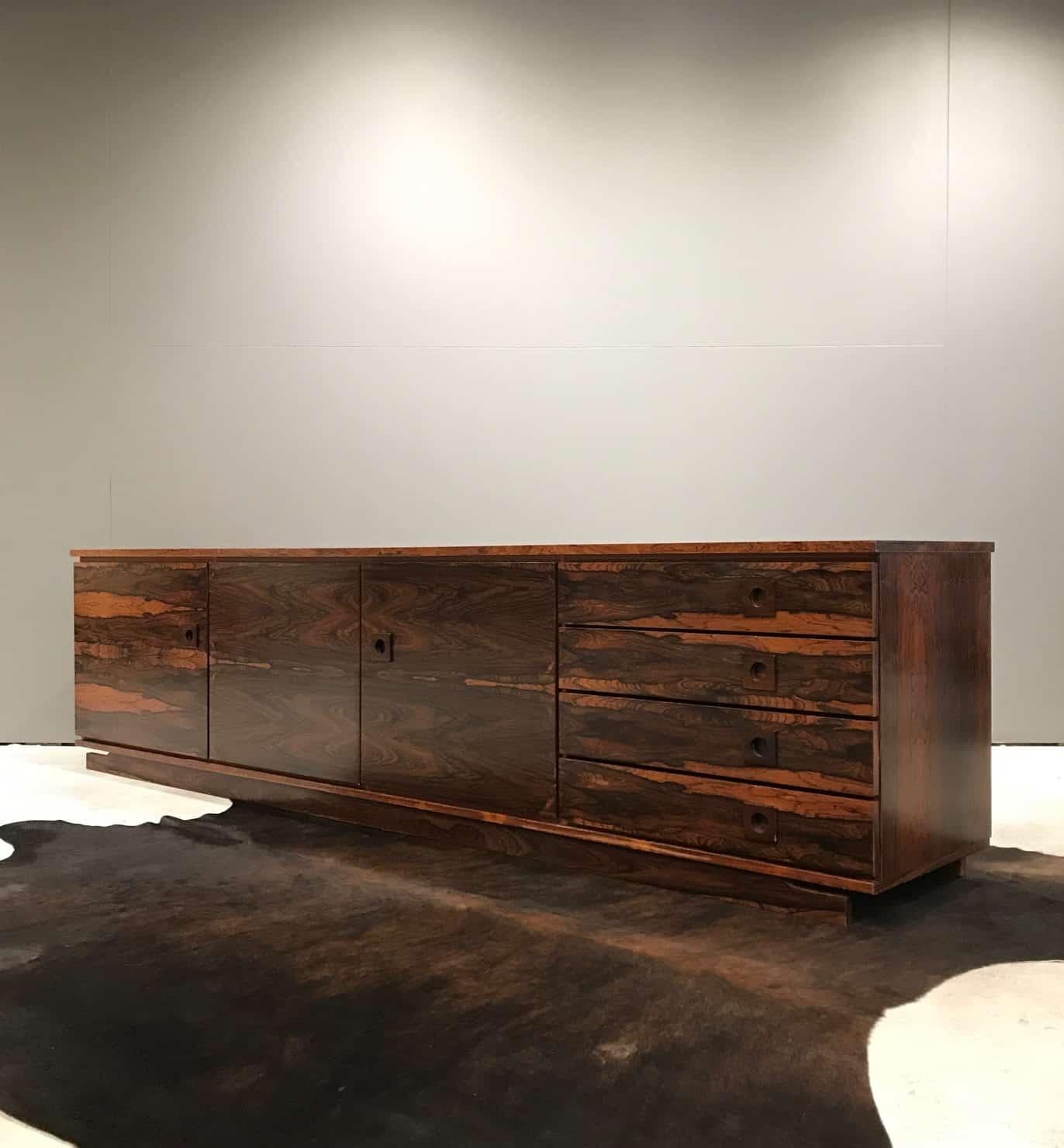 Mid-Century Modern Danish sideboard made from Palisander. Low and sleek, this sideboard looks and feels exotic and stylish.
This item has a Cities certificate.