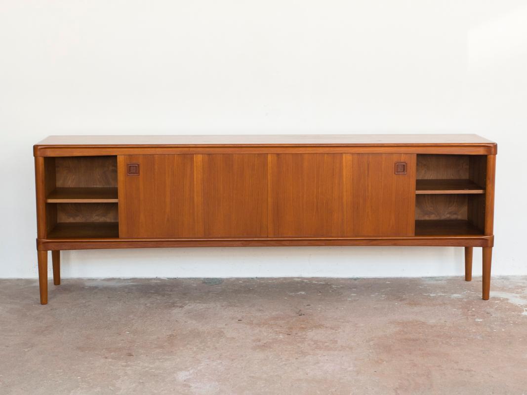 Mid-century sideboard designed by HW Klein and manufactured by Bramin in Denmark in the 1960s. The sideboard has a square shape of the door and drawer handles. The legs are at the corners of the sideboard. The sideboard is made of teak and is in