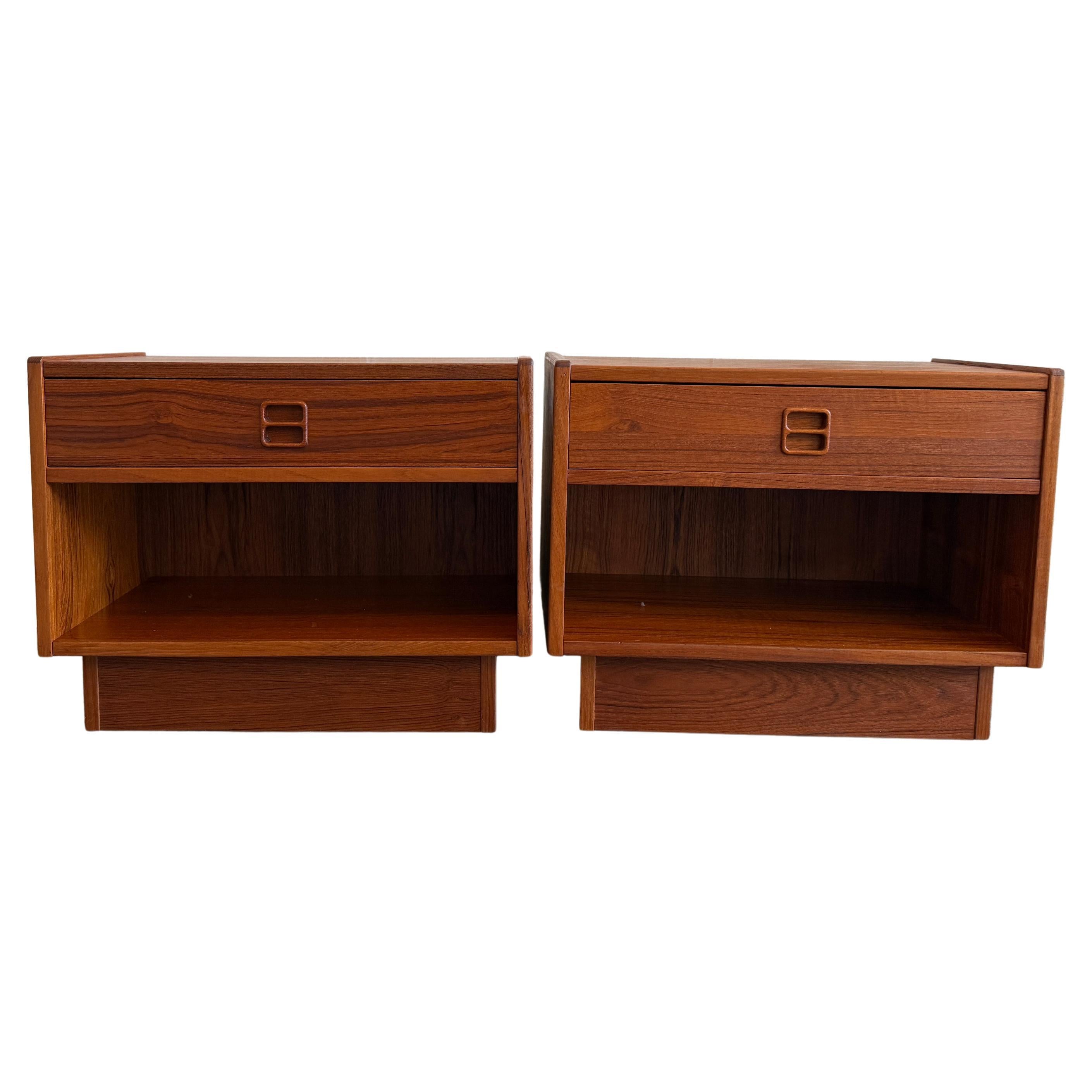 Pair Teak mid century Danish small nightstands by Erik Brouer. Made in Denmark. Each nightstand has a single drawer with carved handle and cubby below. Sits on teak plinth base. Sold as a pair of nightstands (2). Made in Denmark. Located in Brooklyn