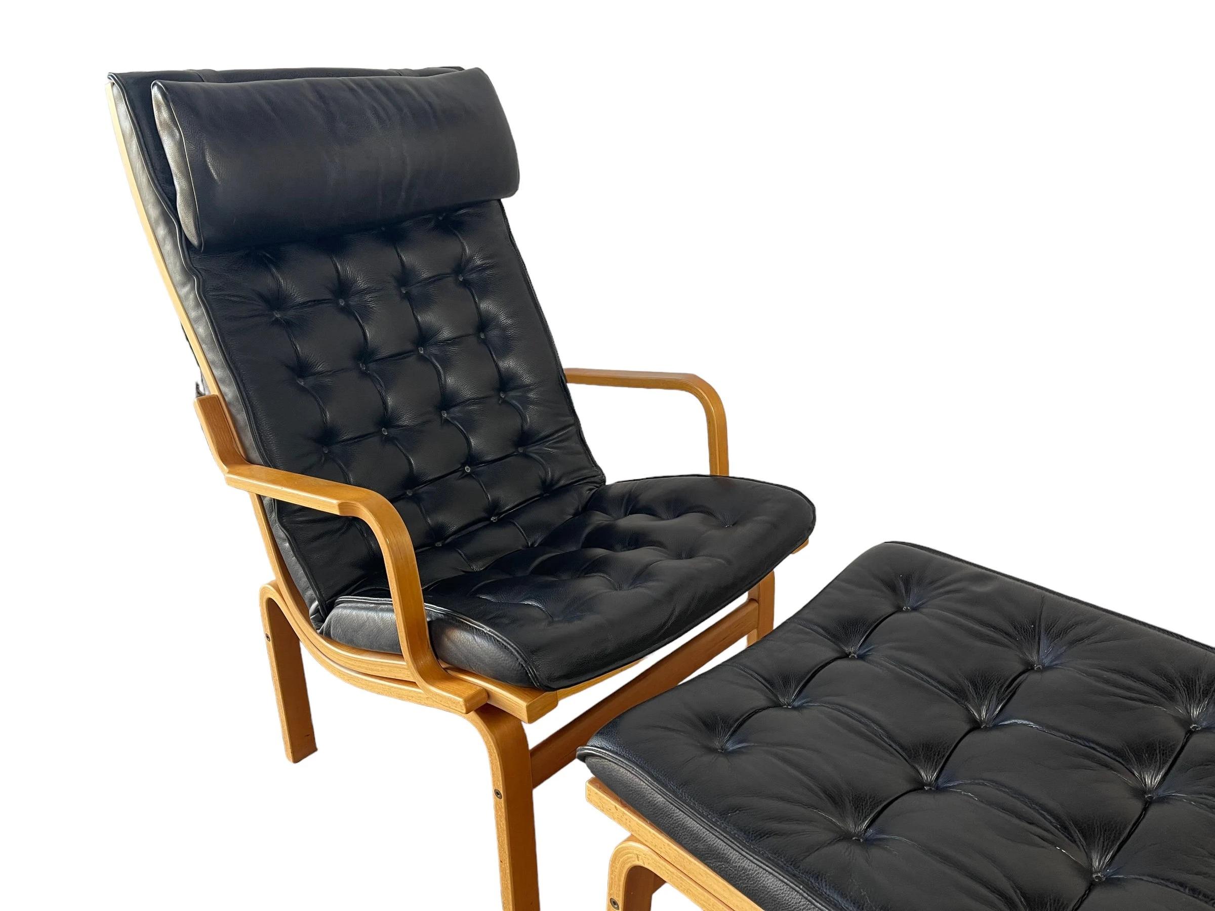 This Mid Century Danish Stouby lounge chair with footrest is a stunning addition to any home decor. Crafted from high-quality wood and upholstered in black, this lounge chair is perfect for relaxing after a long day. Measuring 39 inches in height,