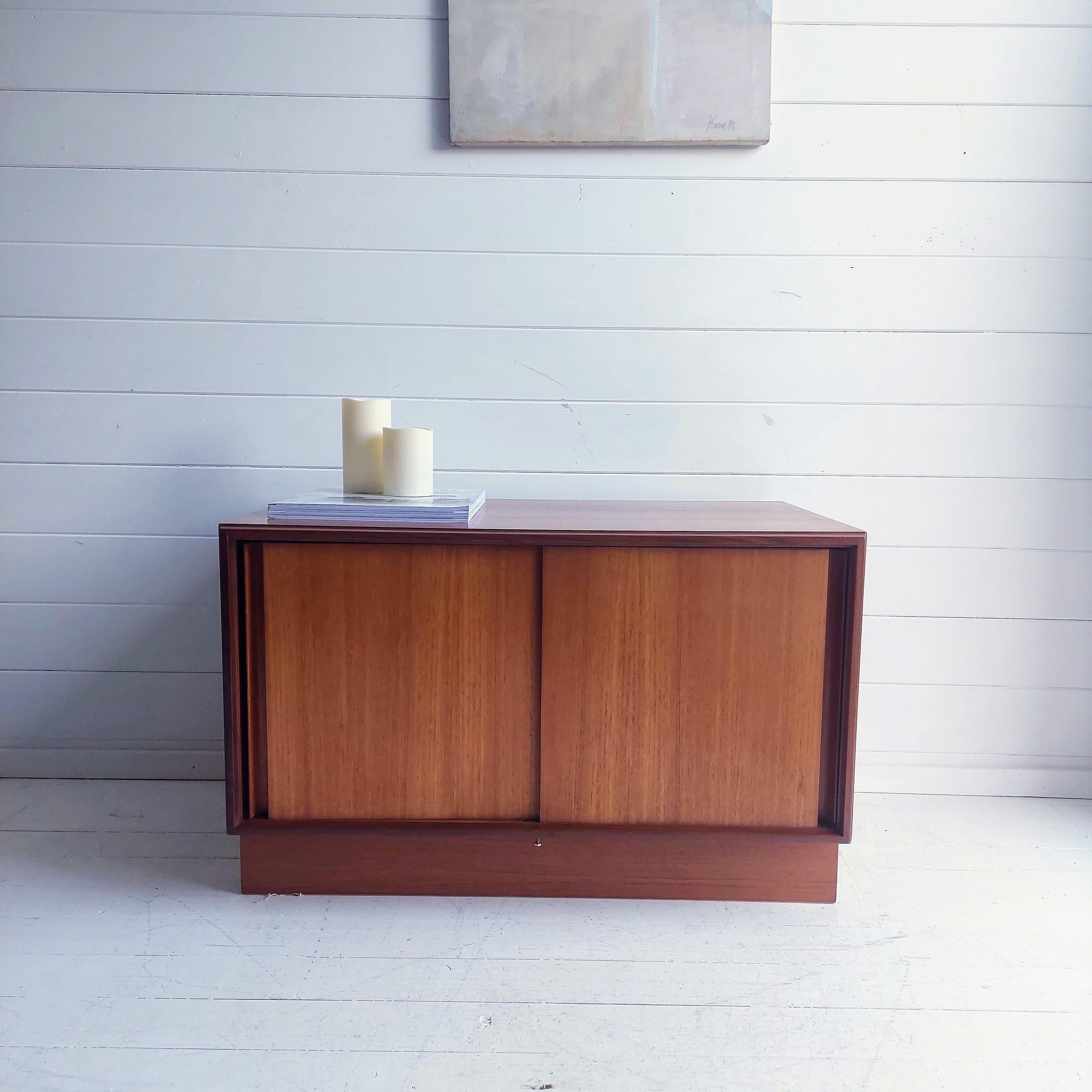 A floor teak sideboard by G-Plan. 
Originally part of a Gplan wall unit from the form Five Range designed by  R Bennet in 1967 and produced until 1970s.

It features 
Sleek and stylish teak piece with two sliding doors
It uses a very clever groove