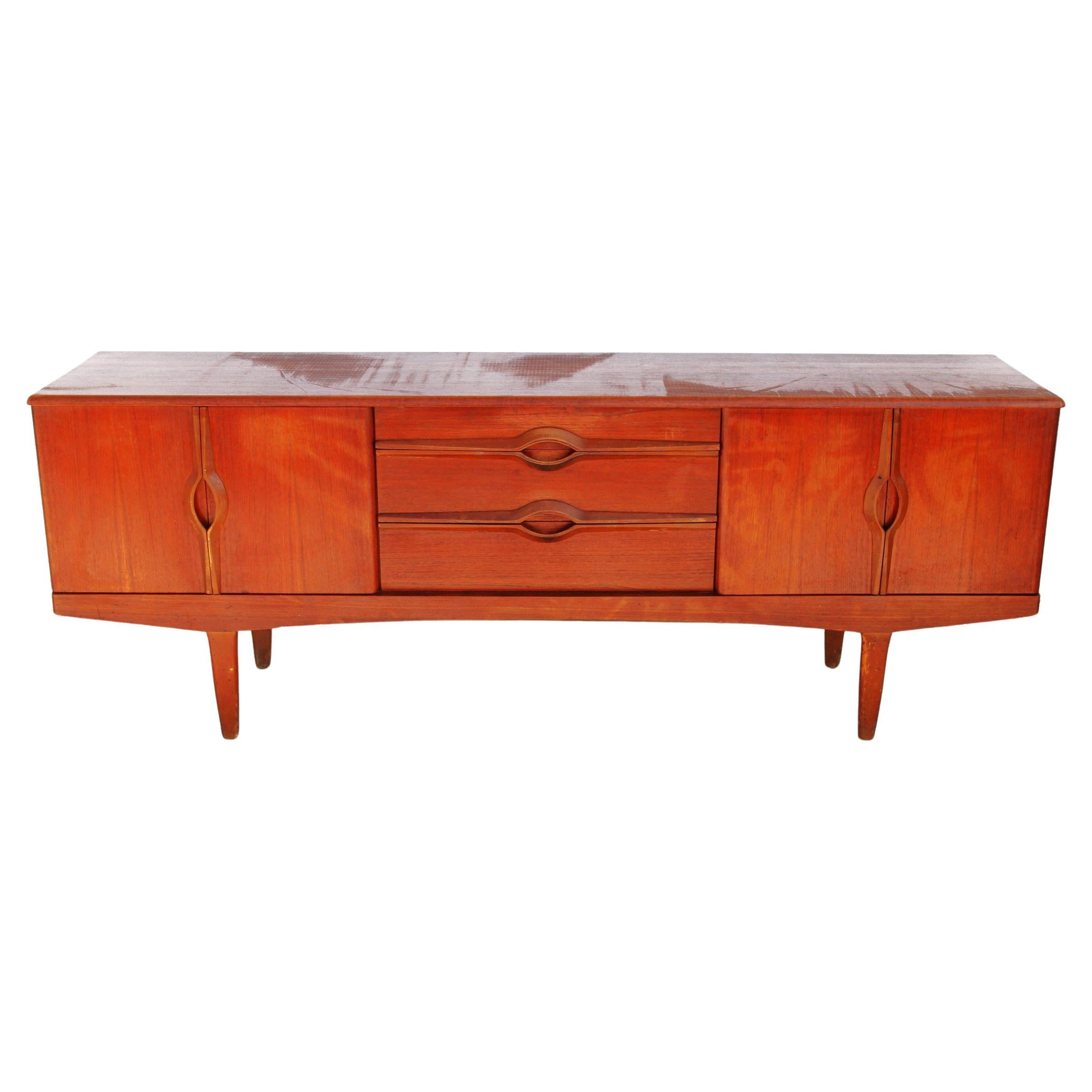 This two-tone walnut sideboard has three central drawers, two compartments with folding doors either side all accented by decorative long thin pale walnut handles giving the piece a unique look.
Dimensions:
Height: 29