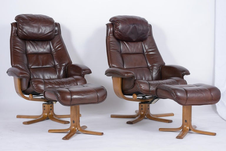 This pair of vintage danish mid-century brown leather lounge chairs and ottomans are upholstered in their original leather in great condition, have been newly dyed a dark brown color, and completely restored by our team of experts craftsmen. The