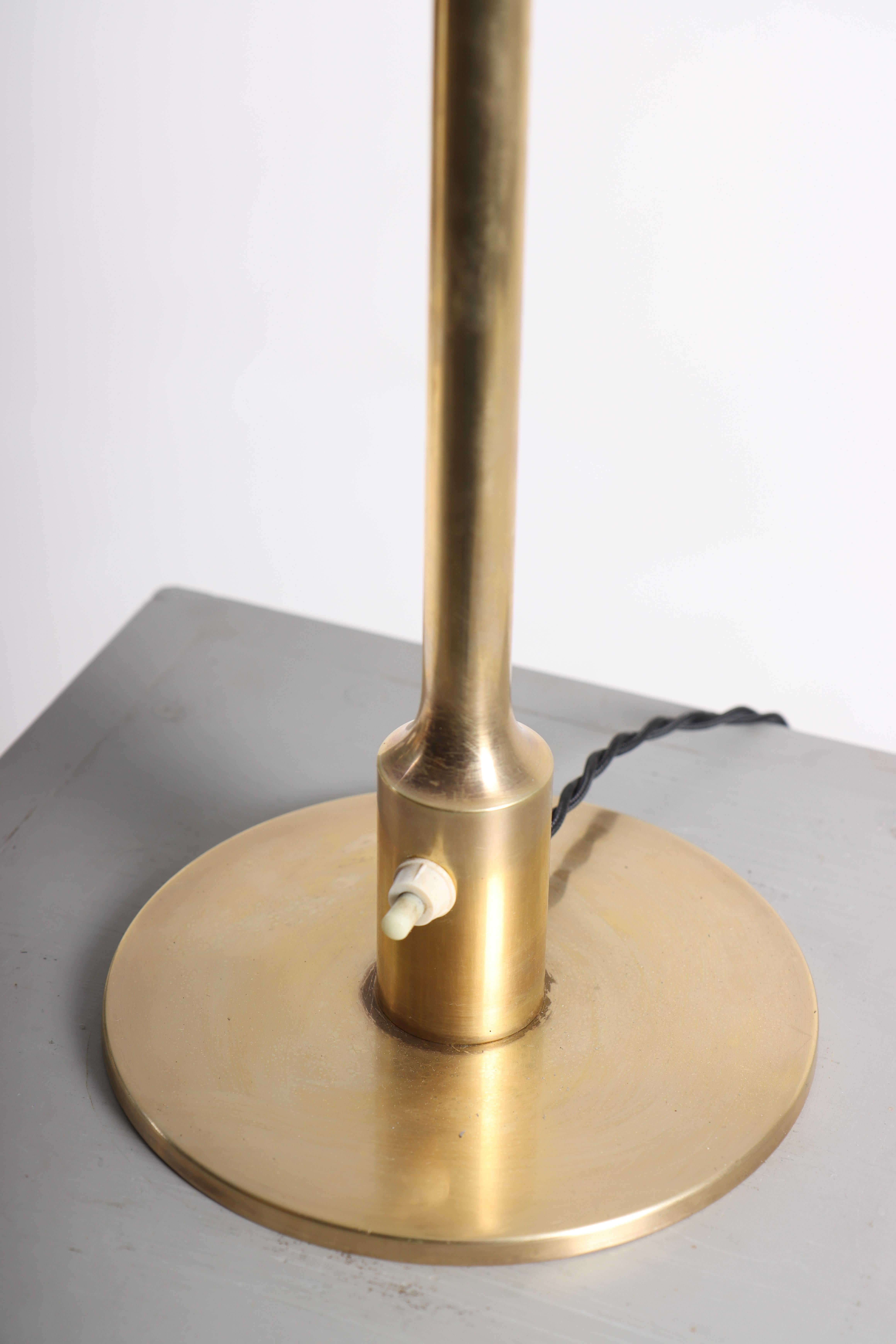 Table lamp in patinated brass, designed and made in Denmark. Great original condition. Comes with a new lampshade.