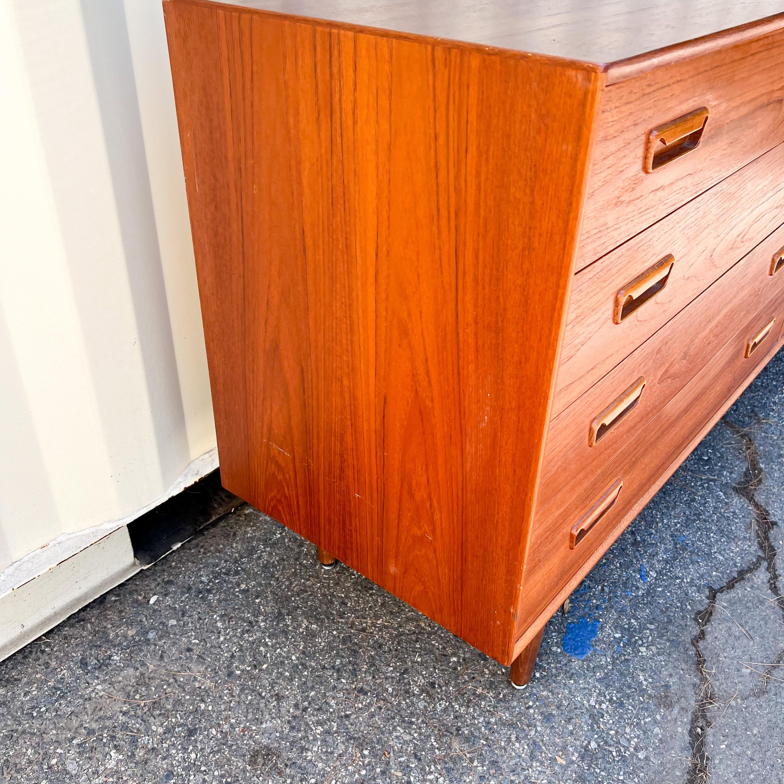 Mid-Century Modern danish teak eight drawer dresser. Some scuffing and scratching to the teak finish.