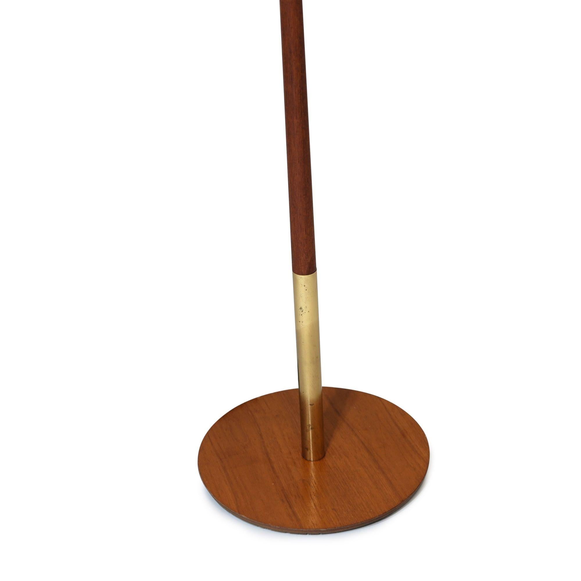 Danish floor lamp of teak and brass with cow hide shade, new wiring with silk cord. 
Lamp H 69.25'' x D 12.5''
Lamp Shade H 12'' x D 24''.