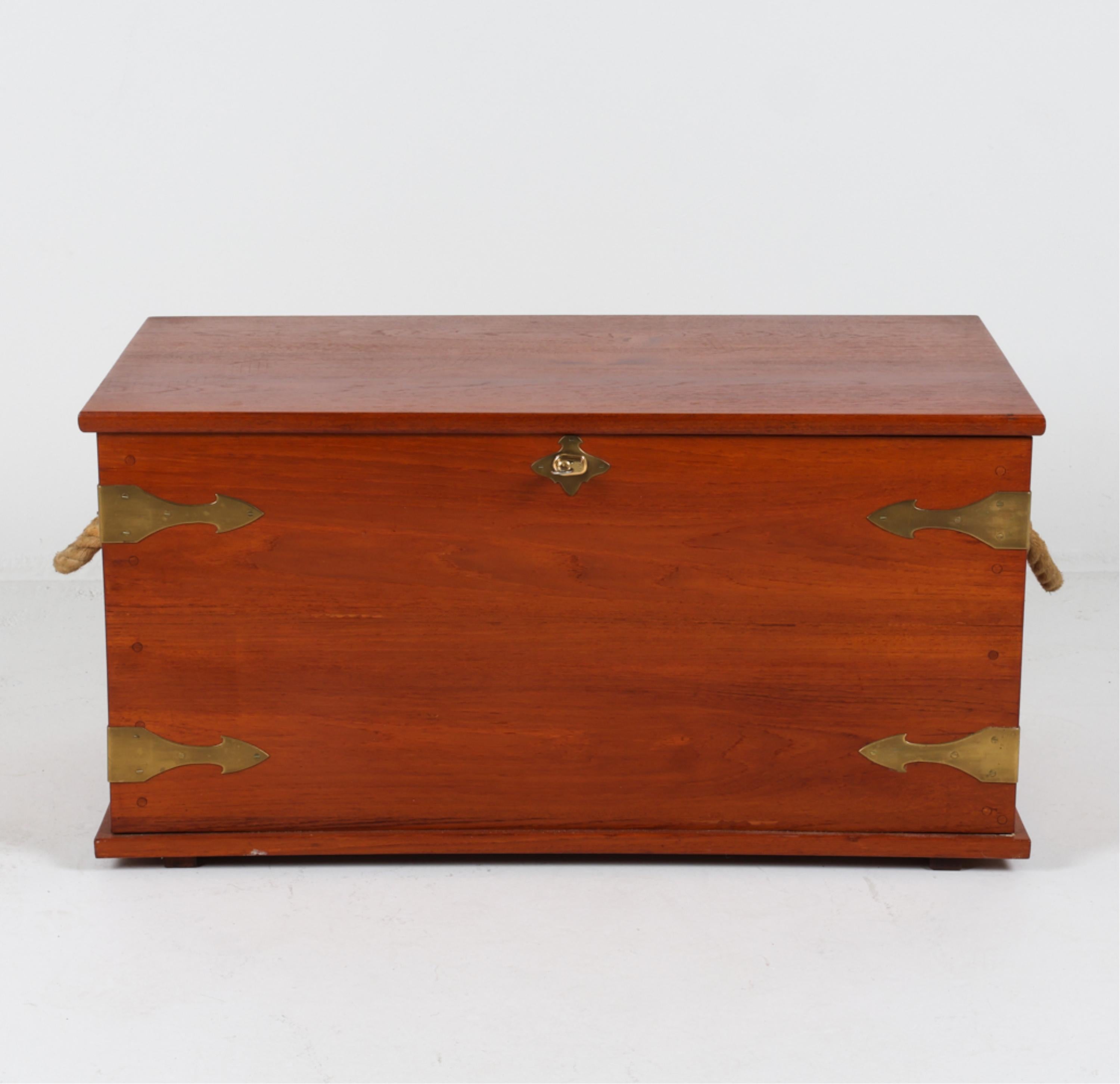 This handsome sea chest is an iconic storage piece, bringing the style of life on the sea into your living room. Crafted from beautiful solid teak wood, the chest boasts a warm reddish tone with the natural grains of the wood on full display. The