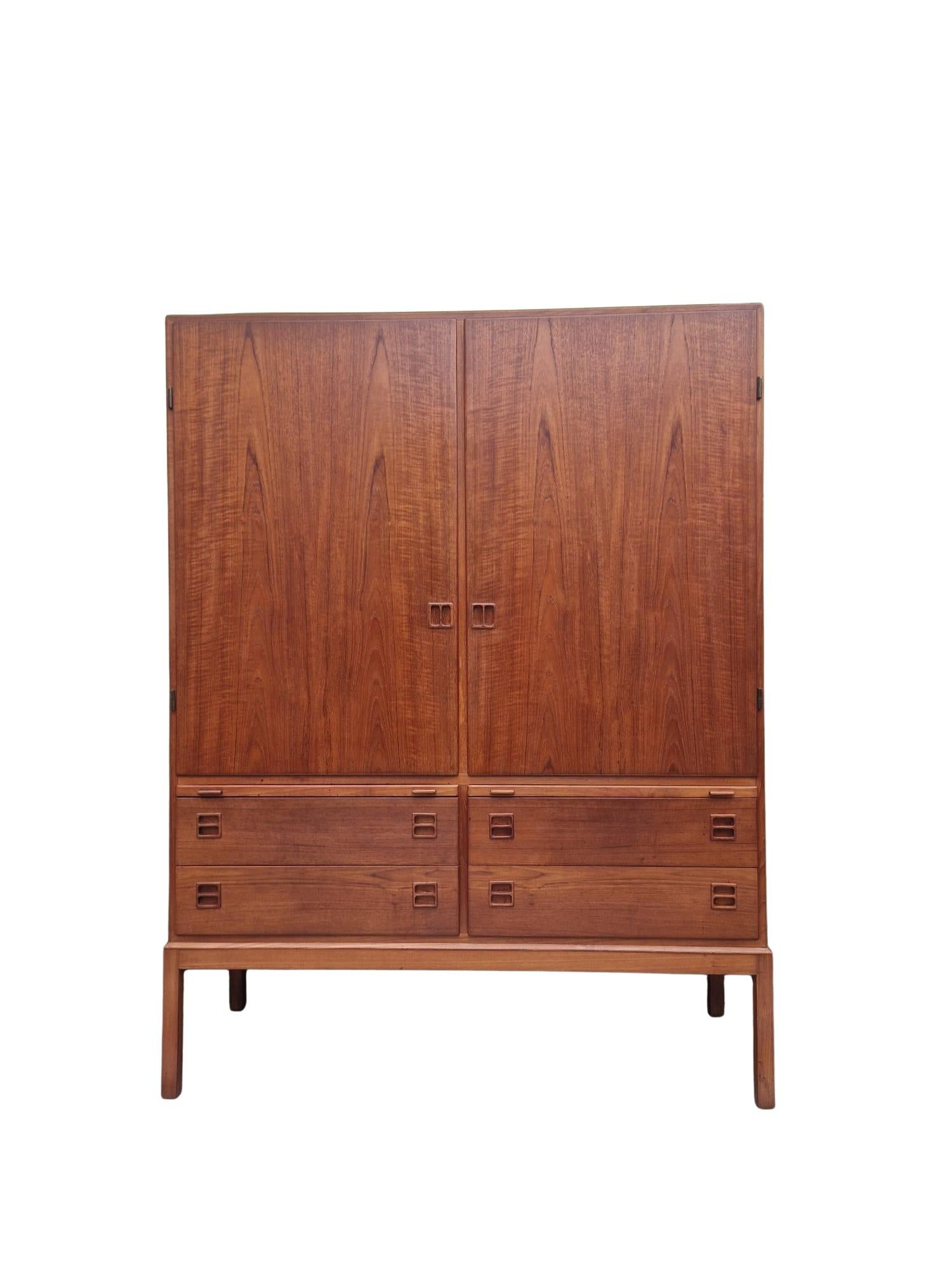 Mid-Century Danish Teak Cabinet by Johannes Andersen for Bernhard Pedersen, C. 1960s

Magnificent mid-century Danish Teak Cabinet / Cupboard by Bernhard Pedersen & Sons, designed by Johannes Andersen.
A large pair of doors opens to reveal shelving,