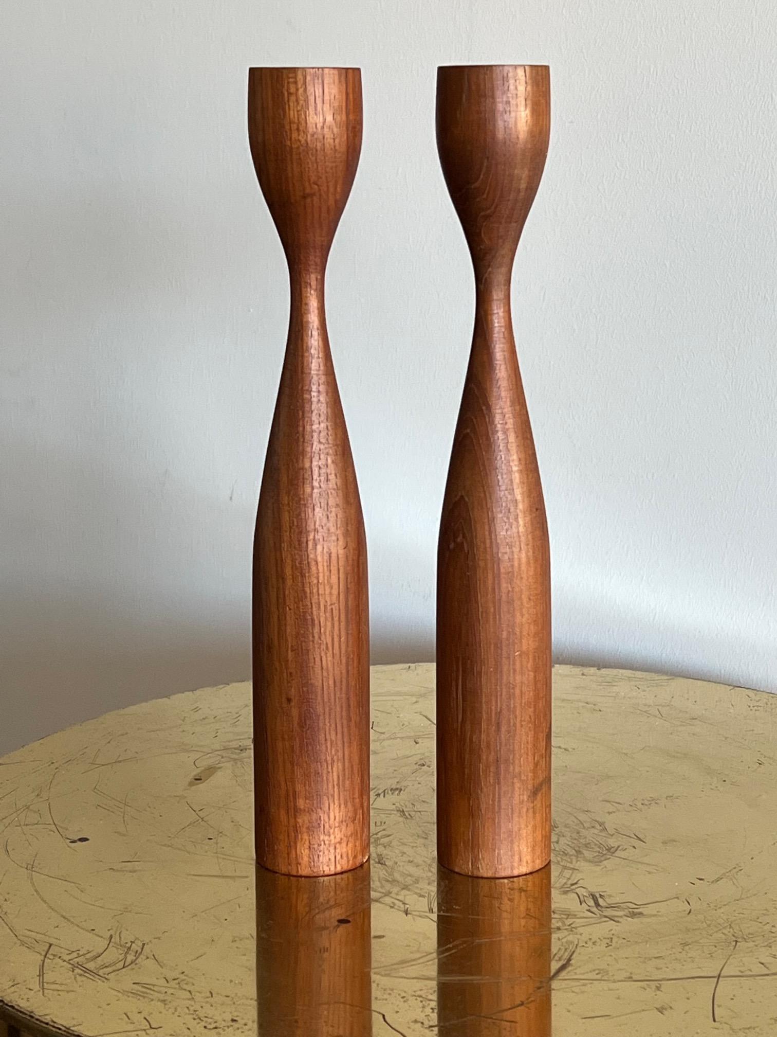 A pair of elegant vintage 1960's candlesticks. Turned teak wood, made in Denmark. Brass candleholders inside. The teak has a really nice graining and vintage patina.