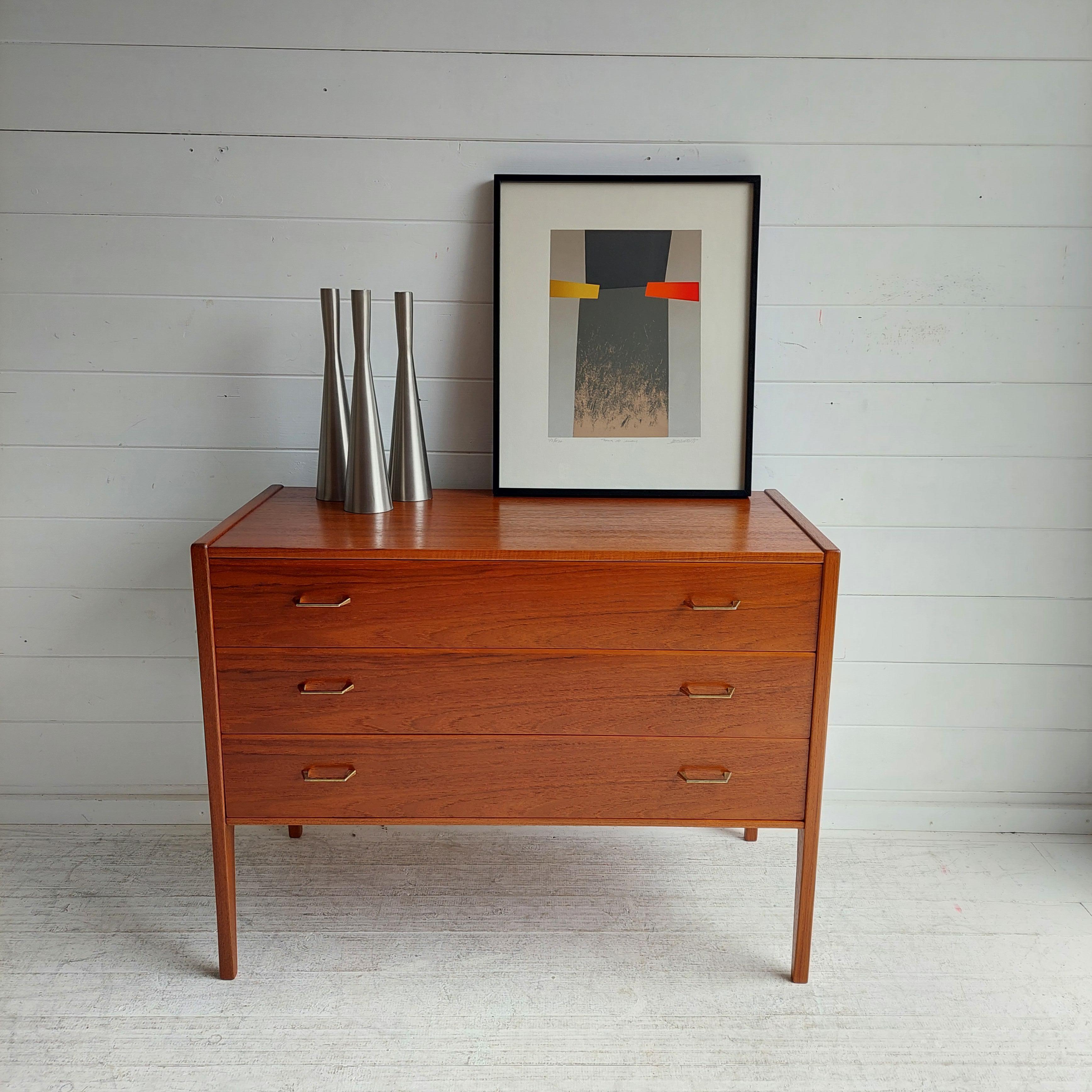 Teak Chest of 3 drawers  by Aksel Kjersgaard for Odder Mobelfabrik in Denmark in the 1960s. 
It is model 34. 
Commonly attributed to Kai Kristiansen

Features:
Wonderful teak grain
The way the legs continue in the body of the chest is remarkable.