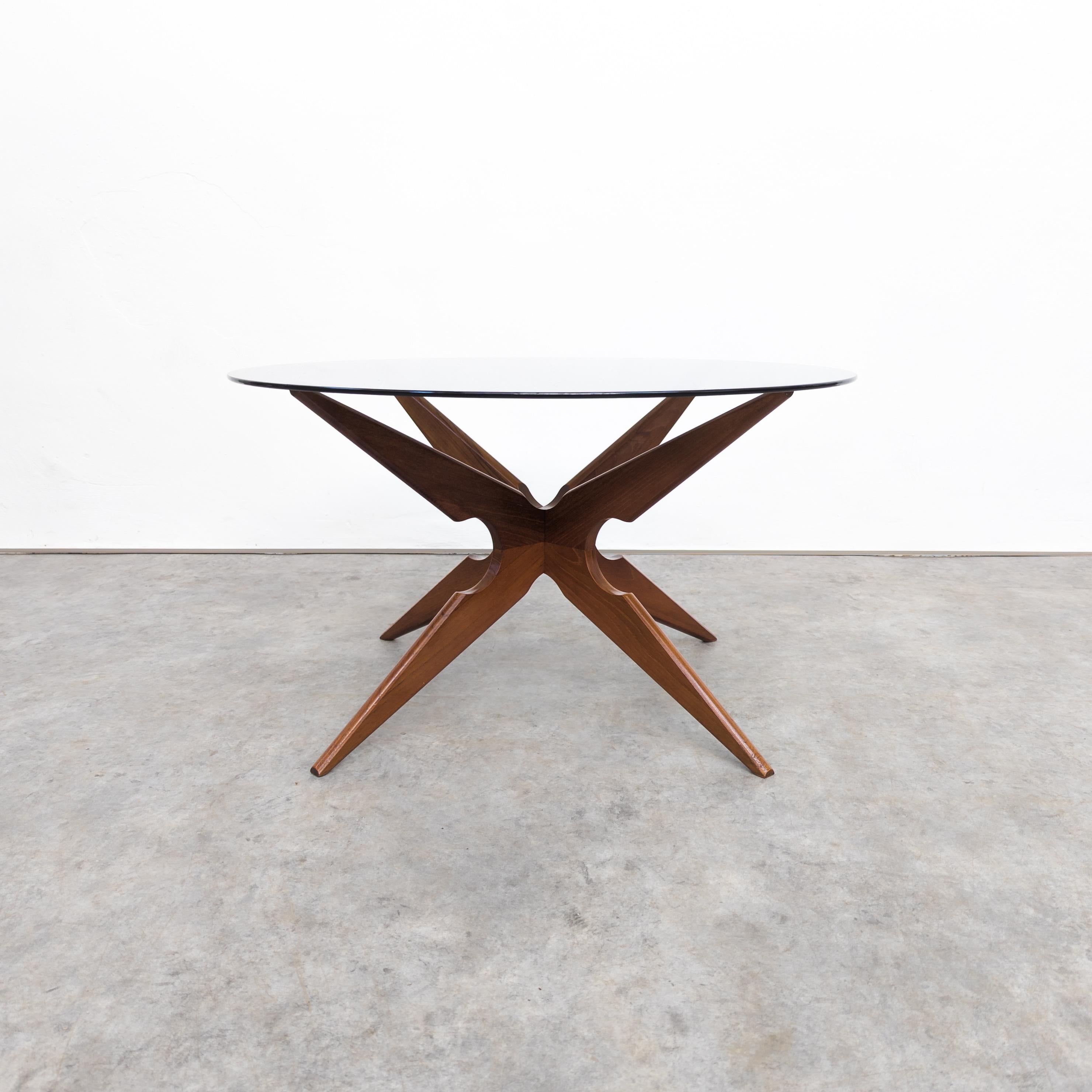 Mid-Century teak and smoked glass spider coffee table by Sika Møbler, Denmark 1960s. Made of two interlocking carved teak elements with 6 mm thick smoked glass. In very good vintage condition with only minor traces of wear on the glass surface. Teak