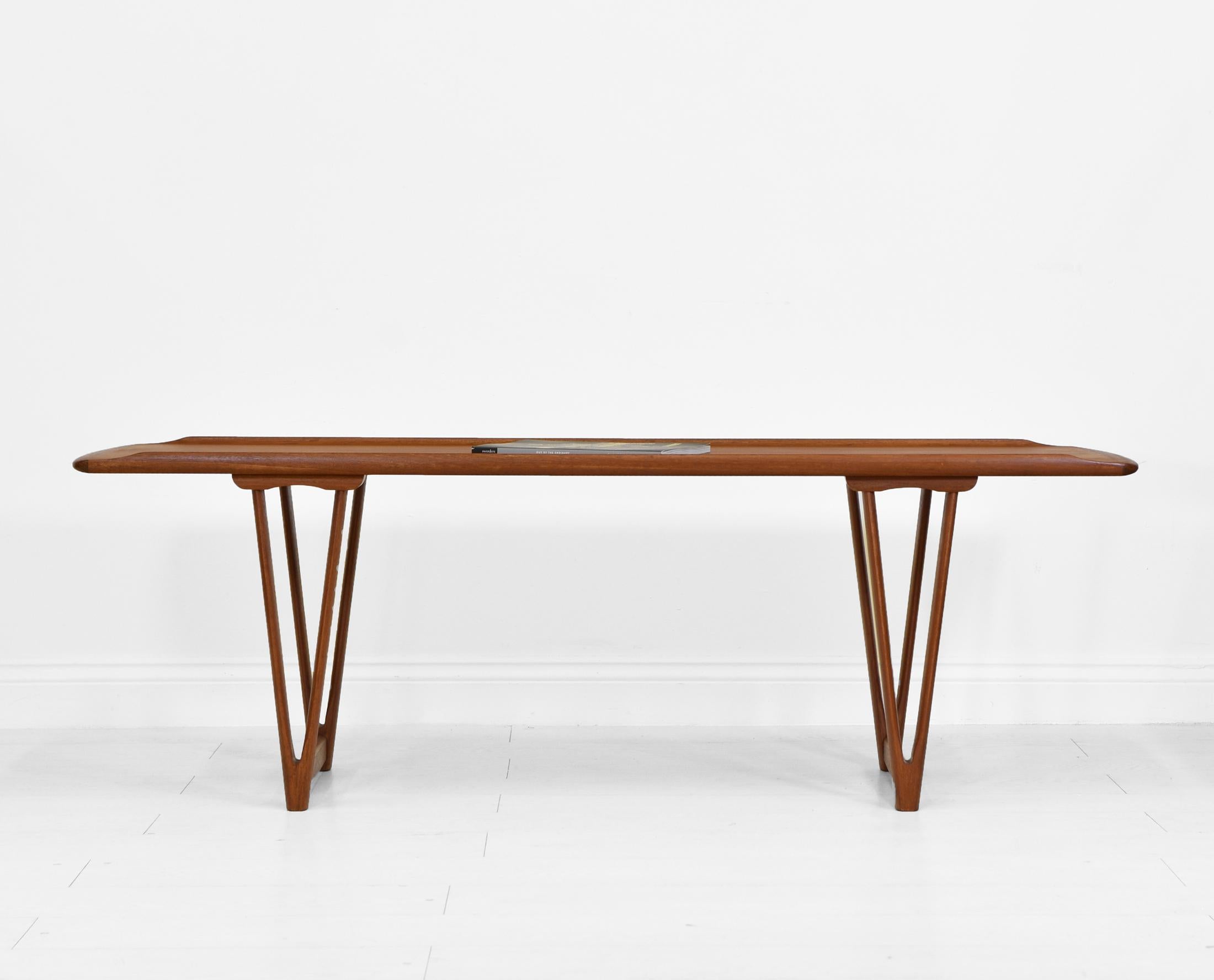 Scandinavian Modern Mid Century Danish Teak Coffee Table on v Shape Supports and Lipped Top Edge For Sale