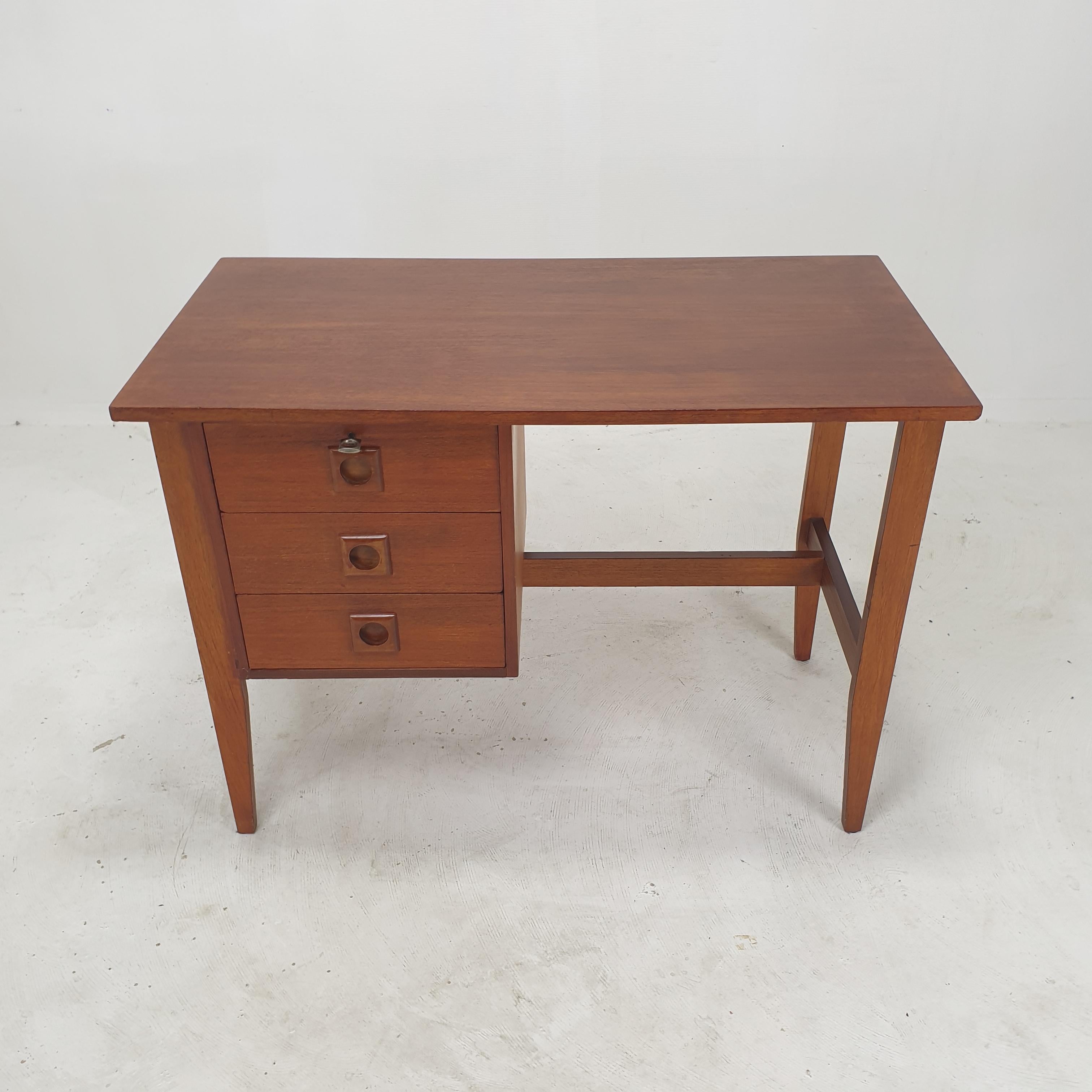 Very nice teak desk, produced in Denmark in the 1970s. 

The desk can be used as free standing thanks to the finished back side.

On the front there are three drawers with the original key.

We work with professional packers and shippers, we