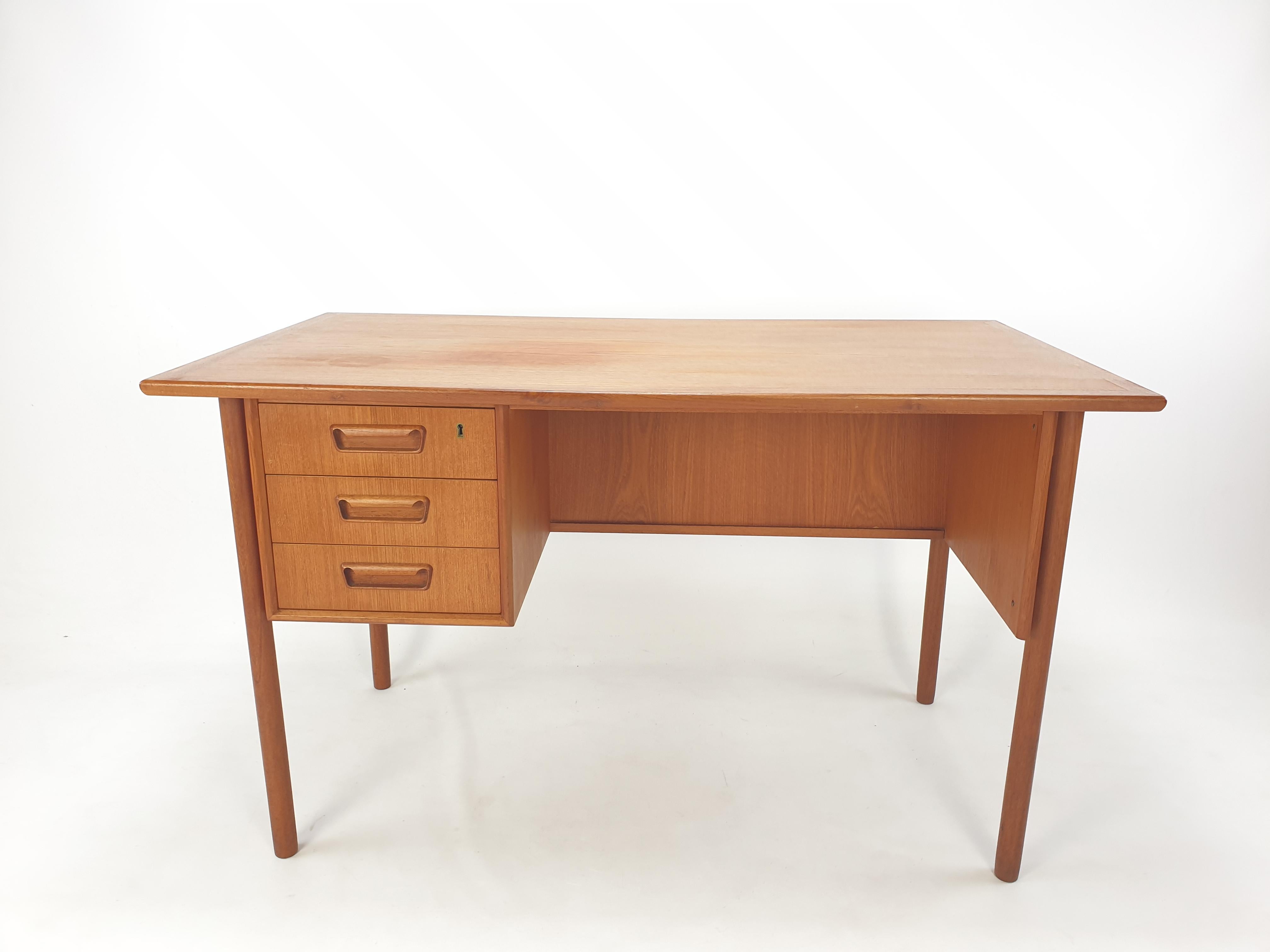 Very nice desk designed by G. Nielsen Tibergaard, produced in Denmark in the 1960s. 

The desk is made of teak and free standing thanks to the finished back side with open storage space for books or other items.

On the front there are three