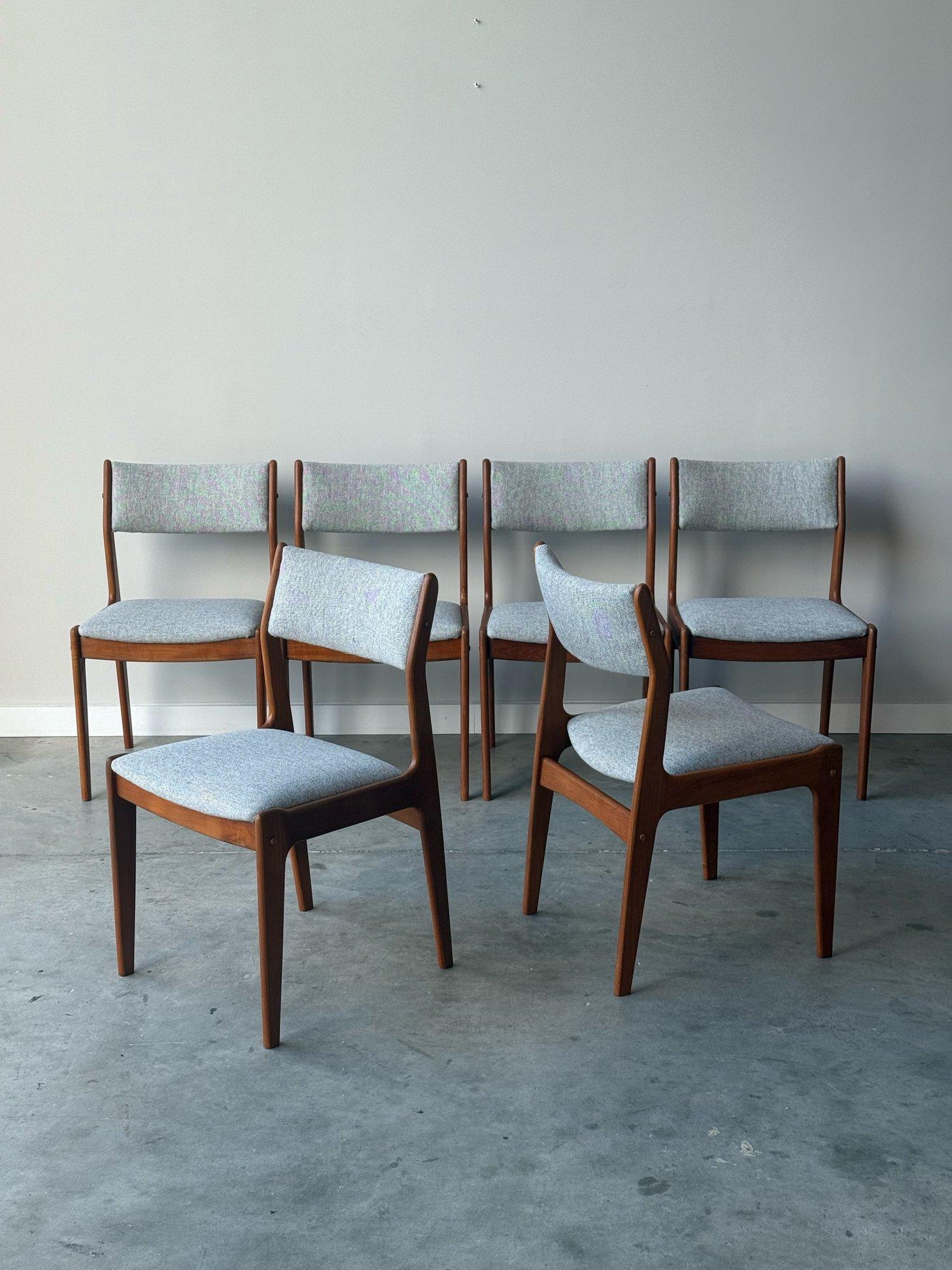 Set of six mid-century dining chairs, made in Denmark. This set is made from sculpted teak wood. The teak wood frames are both sturdy and elegant. Streamlined minimalist frames that feature rounded edges, tapered legs, and are warm in color, yet not