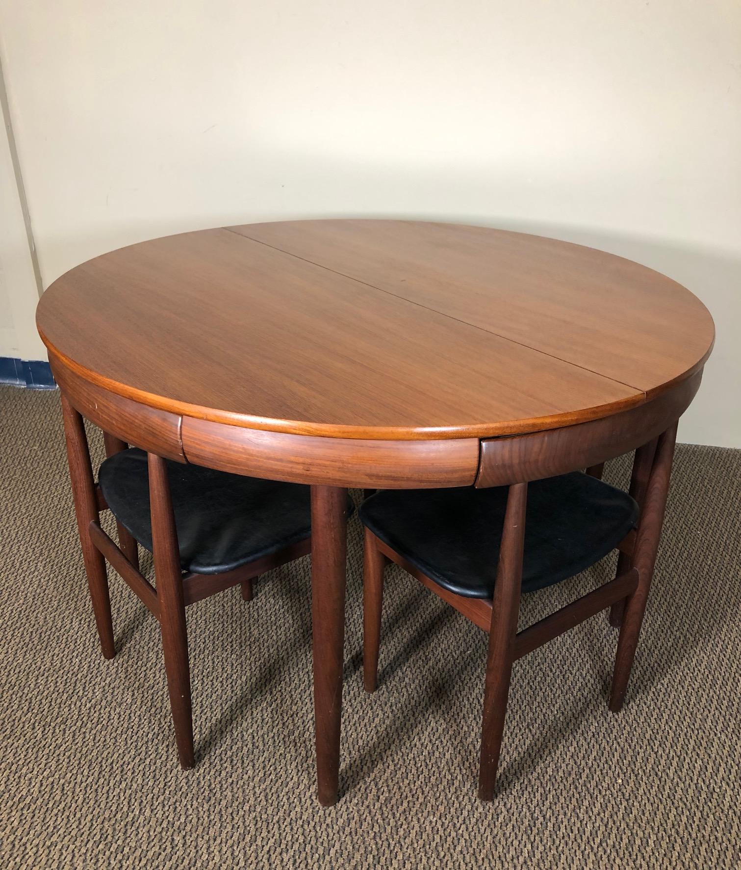 Fantastic Hans Olsen table with 6 chairs. A Danish modern Classic. The chairs fit perfectly underneath the table. Made by Frem Rojle. Table and chairs have the Frem Rojle stamp.
Beautiful dark afromosia teak chairs create a nice contrast to the