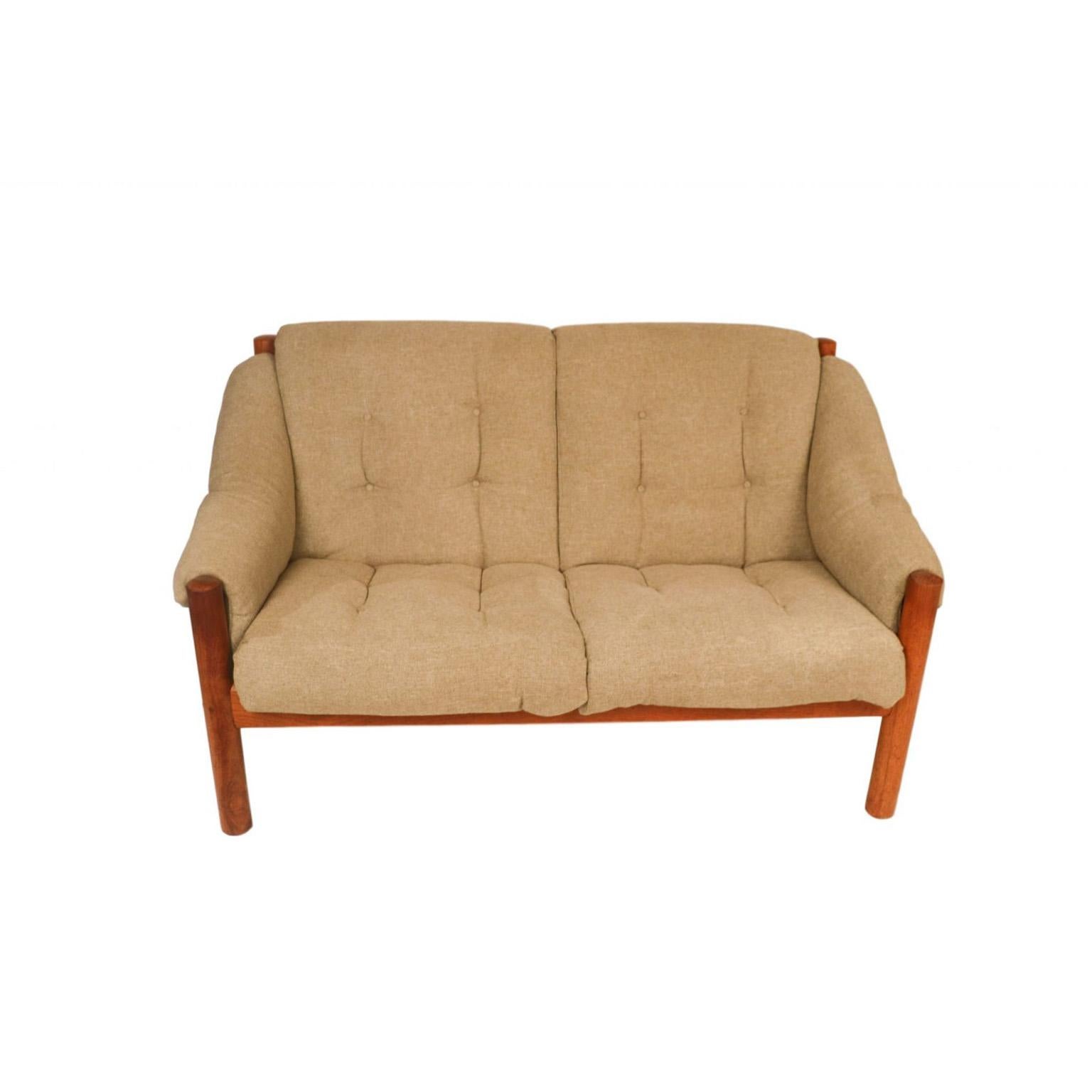 A stunning, comfortable, Mid-Century Modern, Danish 2-seat, teak sofa, settee, loveseat, from Domino Møbler, made in Denmark. An exceptional settee both for its form and quality. This loveseat embodies the whimsical fervour of the period, from