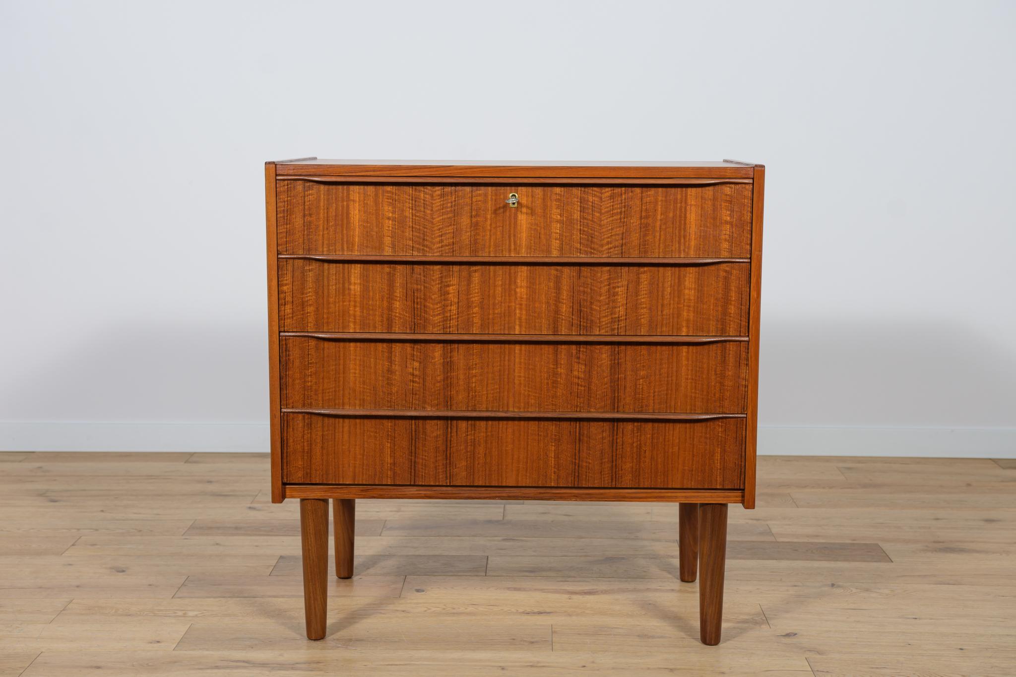 Mid-Century teak dresser made and manufactured during the 1960s in the Denmark. The dresser has profiled handles. The dresser consists of 4 drawers with profiled handles. Teak wood items cleaned from the old surface and finished with quality Danish