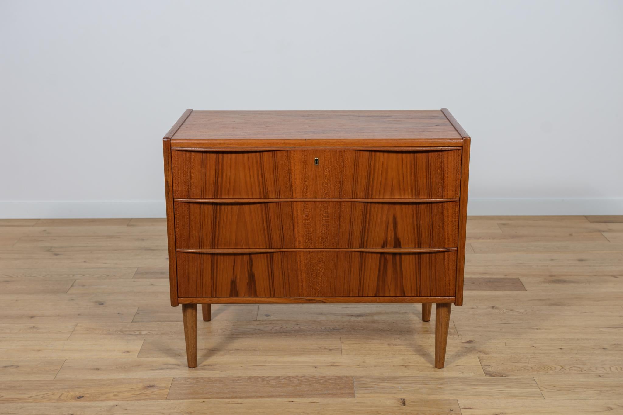 Mid Century teak dresser made and manufactured during the 1960s in the Denmark. The dresser has profiled handles. The dresser consists of 4 drawers with profiled handles. Teak wood items cleaned from the old surface and finished with Danish oil