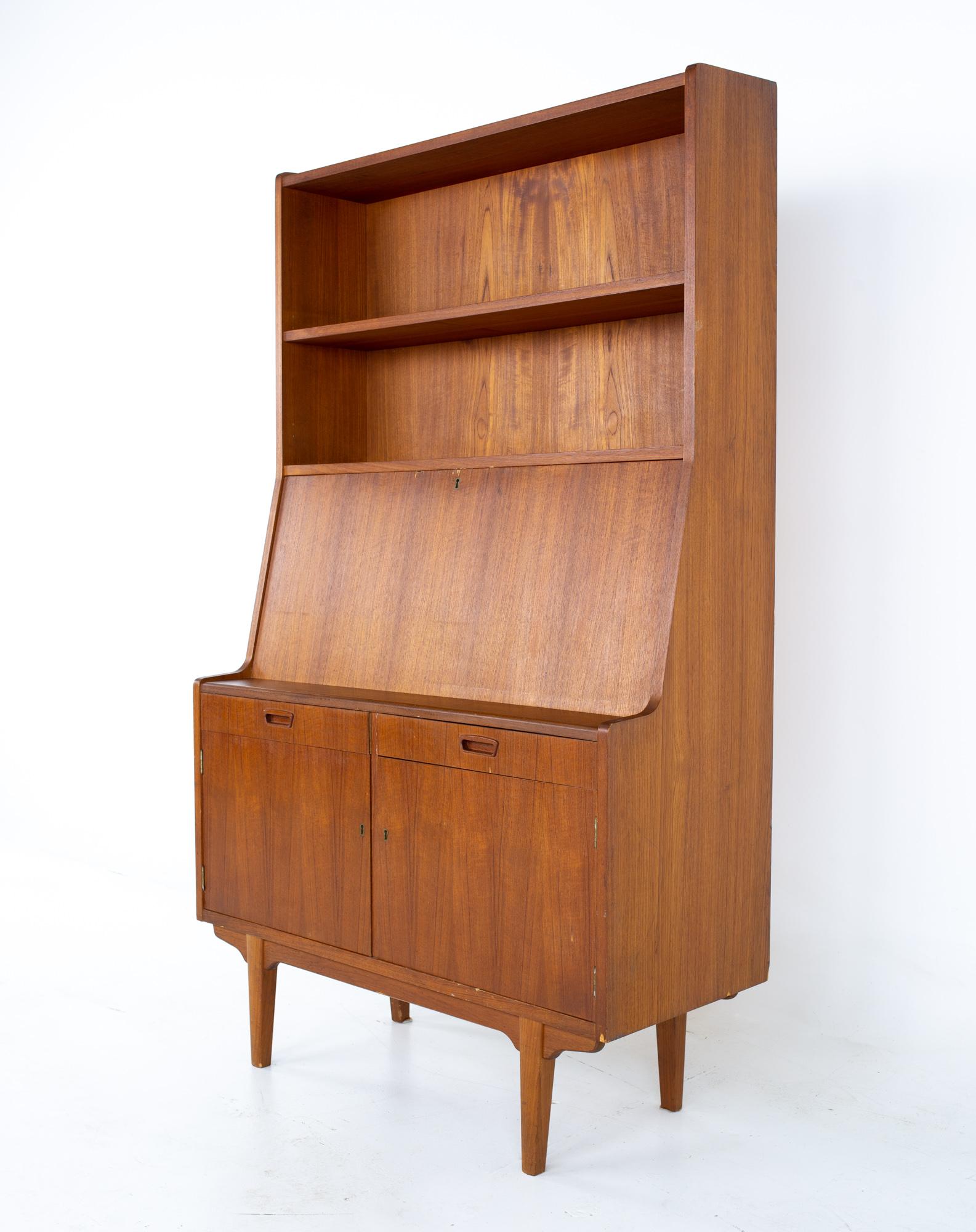 Mid Century Danish teak drop front secretary desk bar bookcase
Bookcase measures: 39.5 wide x 16.75 deep x 65.75 inches high

All pieces of furniture can be had in what we call restored vintage condition. That means the piece is restored upon