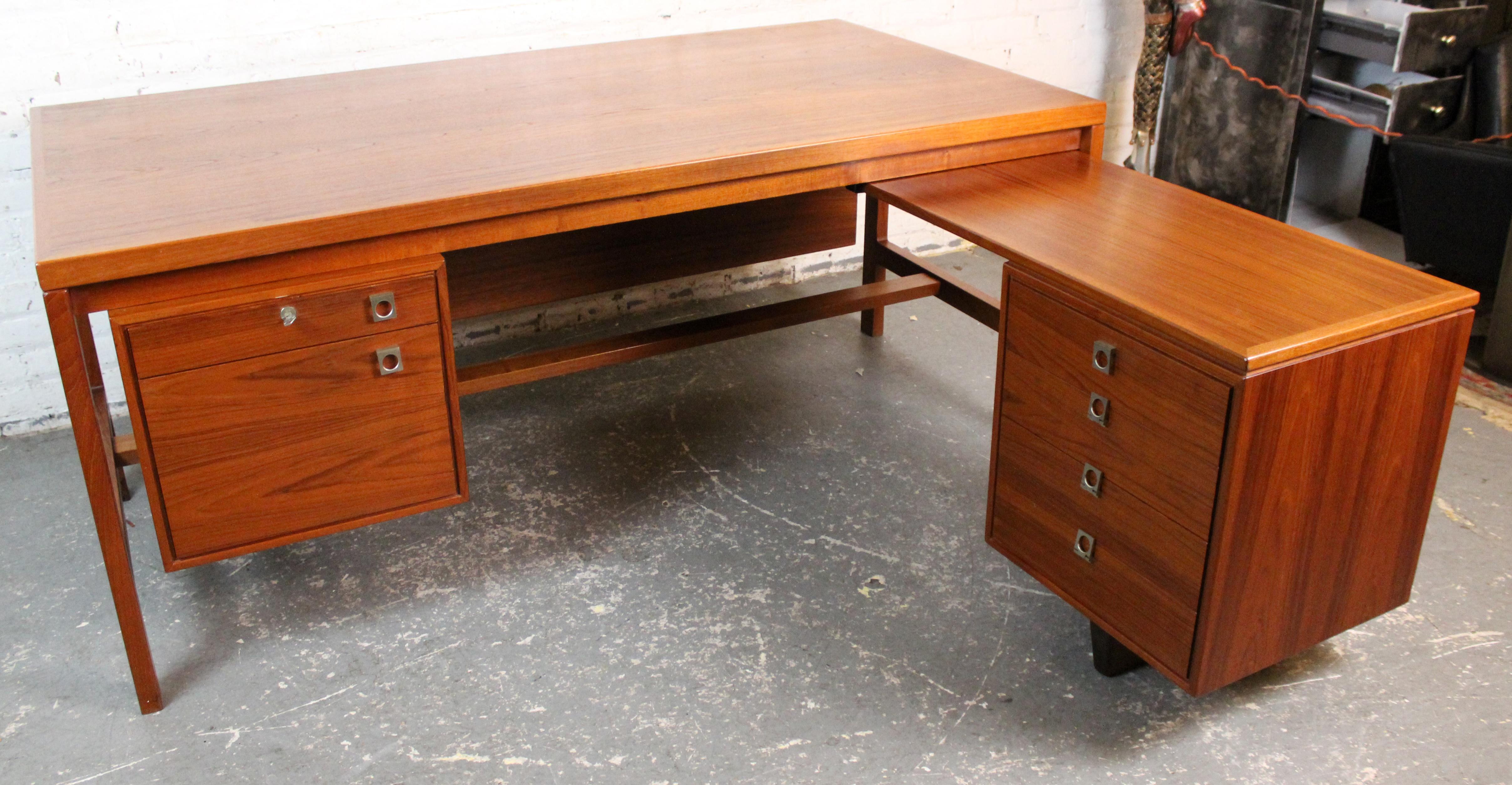 A rare and refined mid-century Danish executive desk designed by Arne Vodder for H.P. Hansen Møbelfabrik, Denmark, circa 1960s. Crafted in richly grained teak with refined, balanced proportions, it features a floating main writing surface and