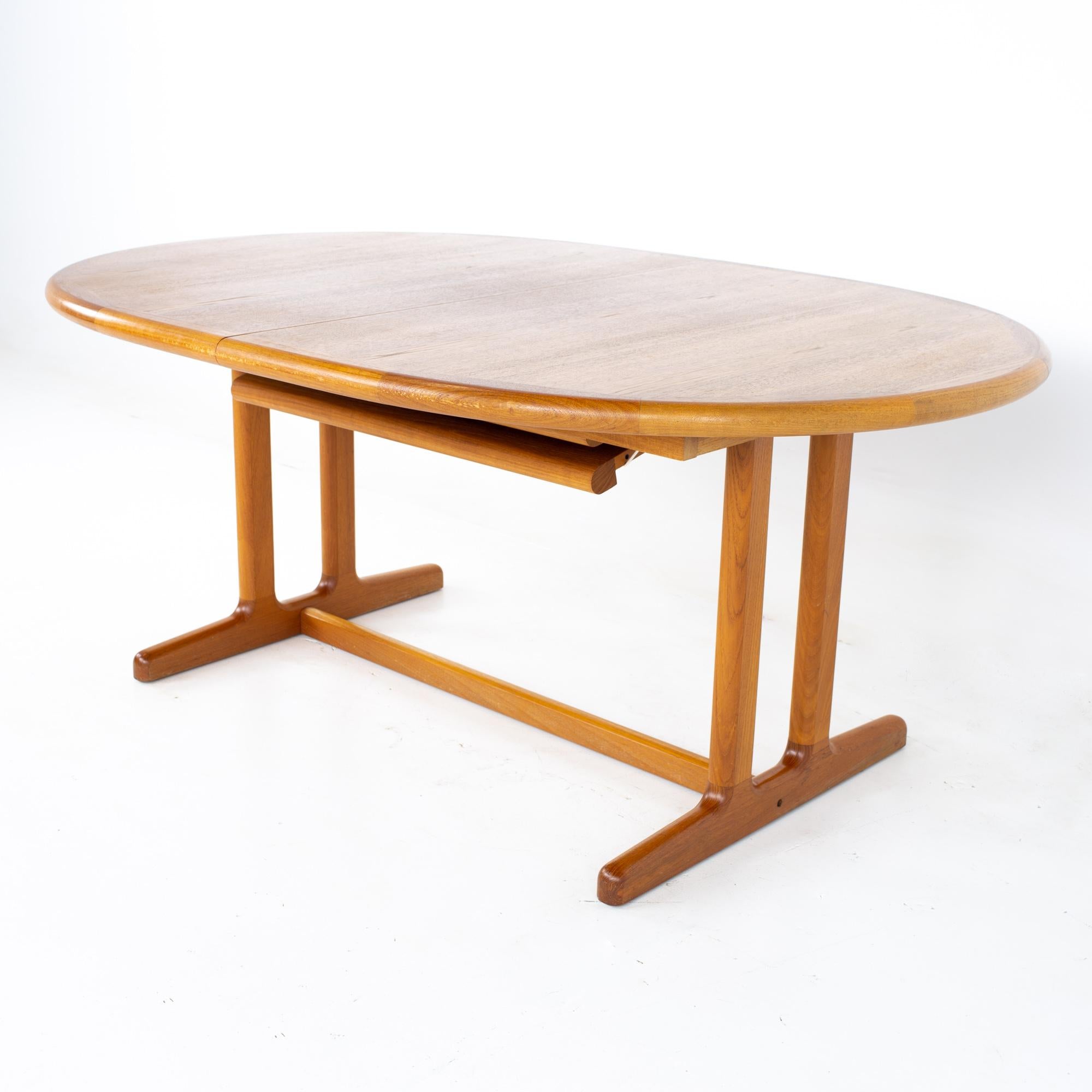 Mid century Danish teak expanding hidden leaf dining table.
Table measures: 68 wide x 45 deep x 28.5 inches high; the leaf is 31.25 inches wide, making a maximum table width of 99.25 inches when the leaf is used 

All pieces of furniture can be