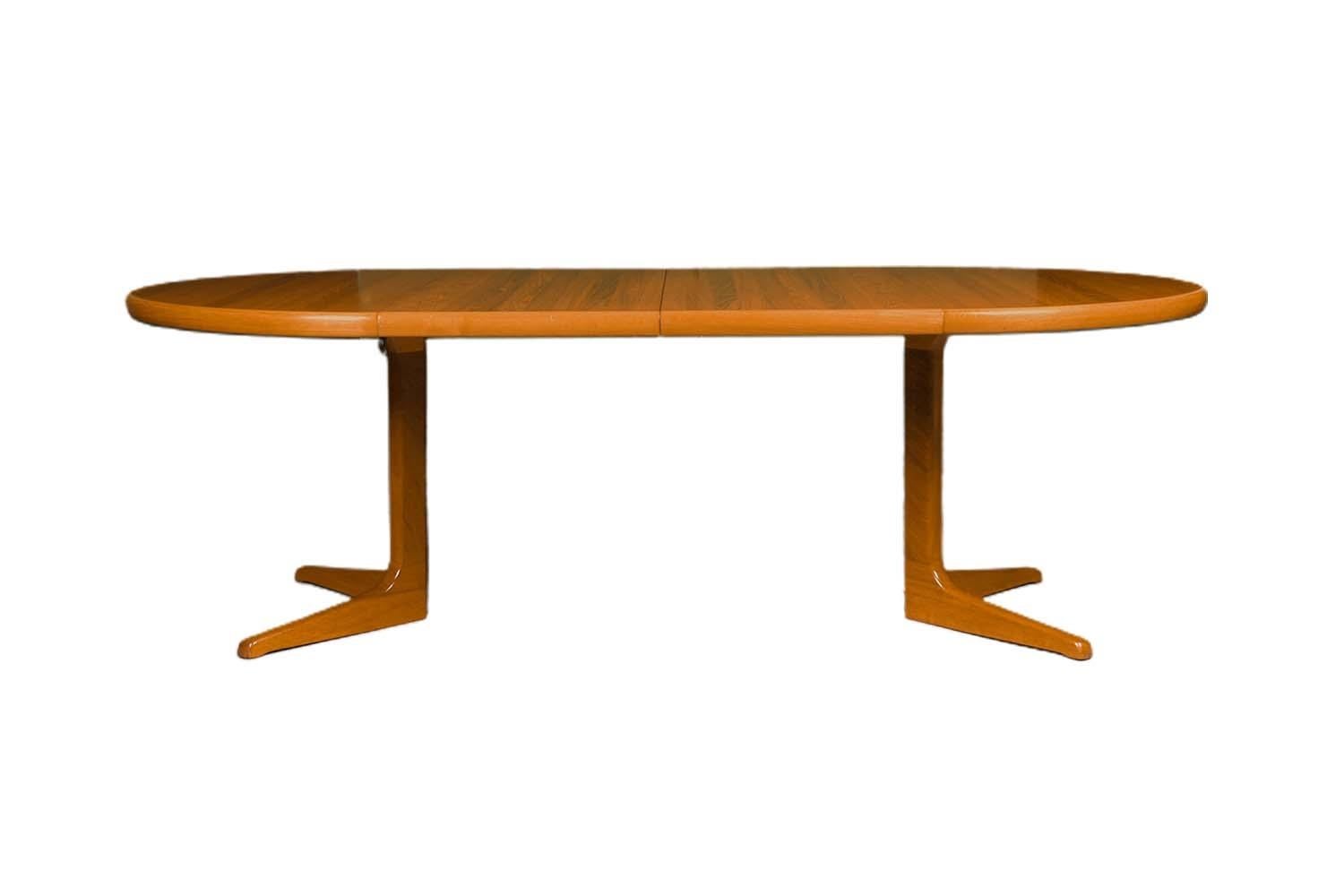 Beautiful Mid-Century Modern expandable round dining table, manufactured in Denmark. Featuring richly grained, gleaming teak and smooth, clean lines characteristic of classic Danish design, remains in original condition throughout. This remarkable