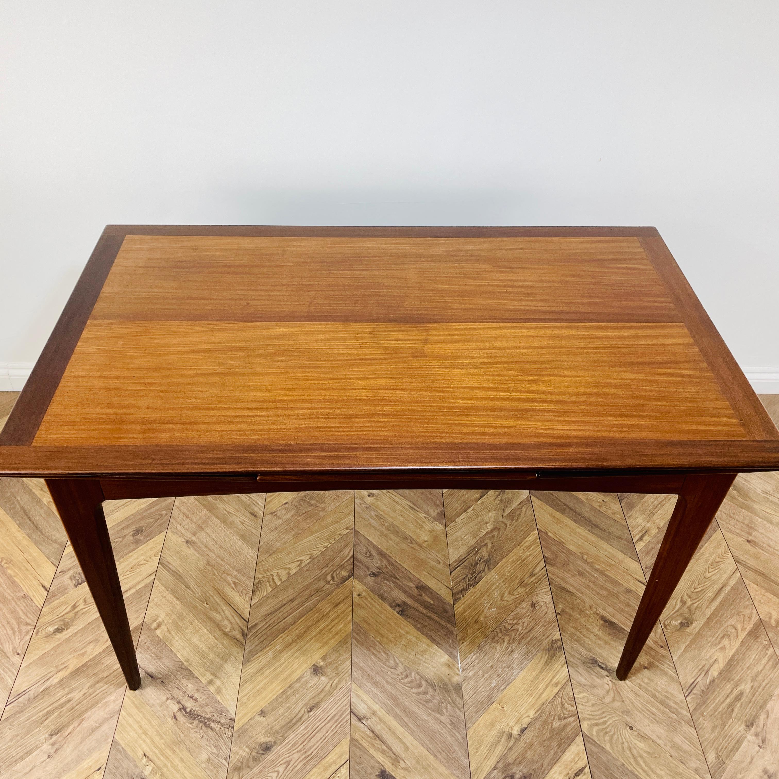 Mid-Century Extending Dining, Made in Denmark, circa 1960s.

A beautifully designed table made from teak, with extending leaves, which are concealed underneath.

The table boasts bullet edges and is in very good vintage condition, with only light