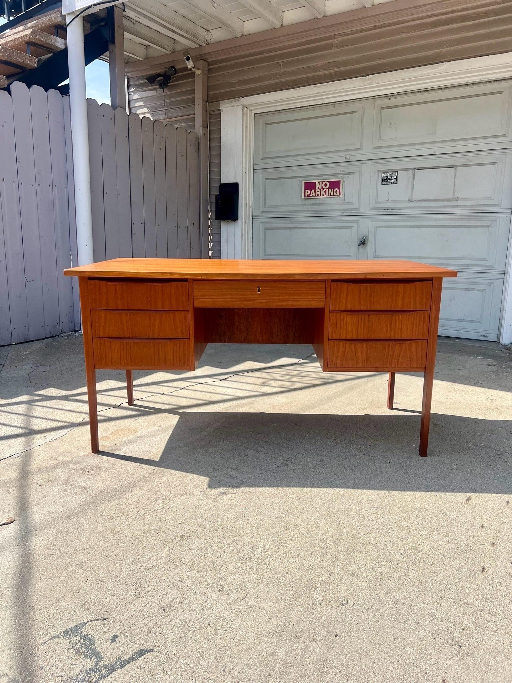 This gorgeous danish designed desk features seven drawers and id dual-sided. Can be floated in an office or study, or placed against a wall. The classic danish design seamlessly merges form and function for a workspace. Overall excellent vintage