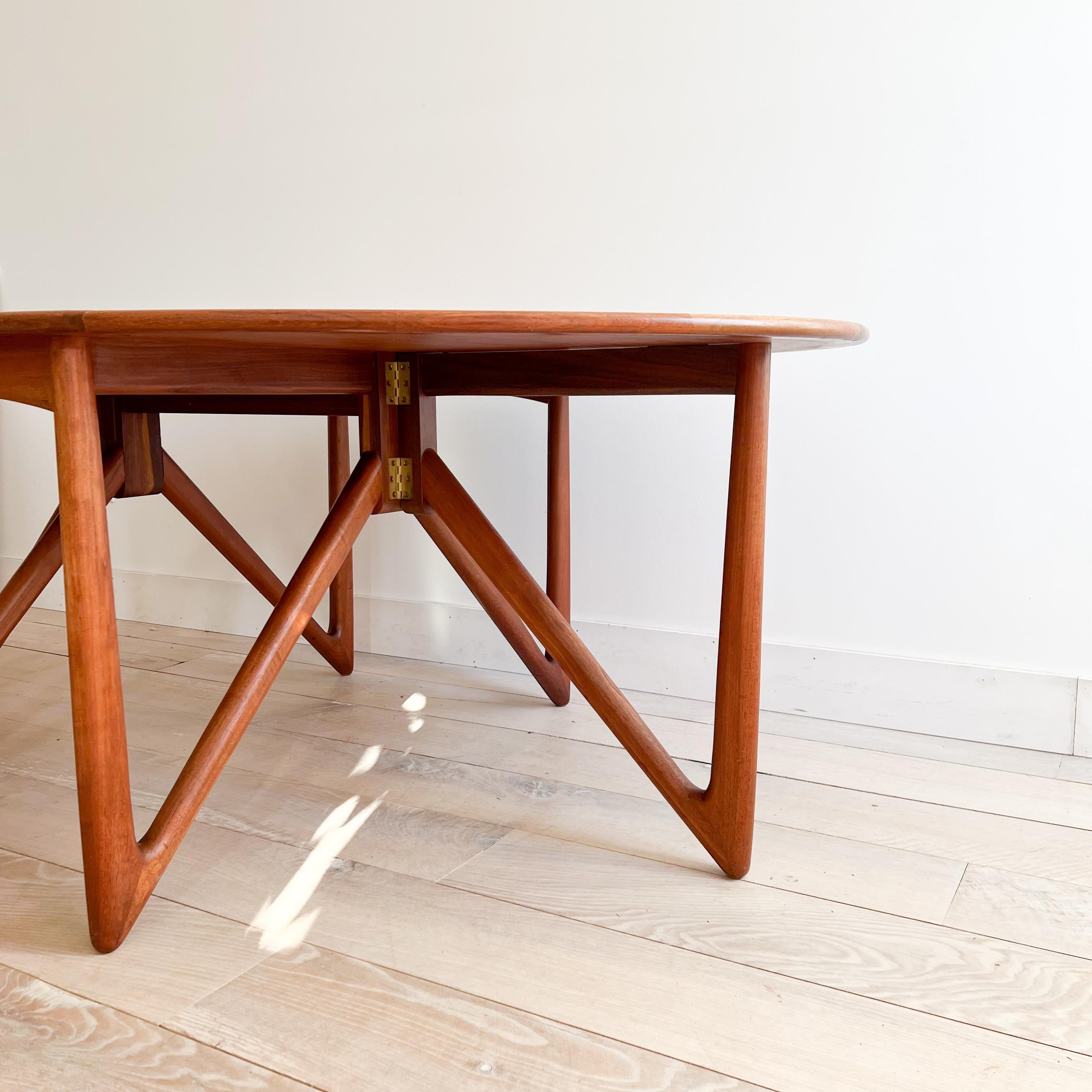 Discover a stunning piece of mid-century modern design with this Danish teak gateleg dining table crafted by Niels Koefoed. Featuring a sleek silhouette and exquisite teak wood construction, this table exudes timeless elegance. The original finish