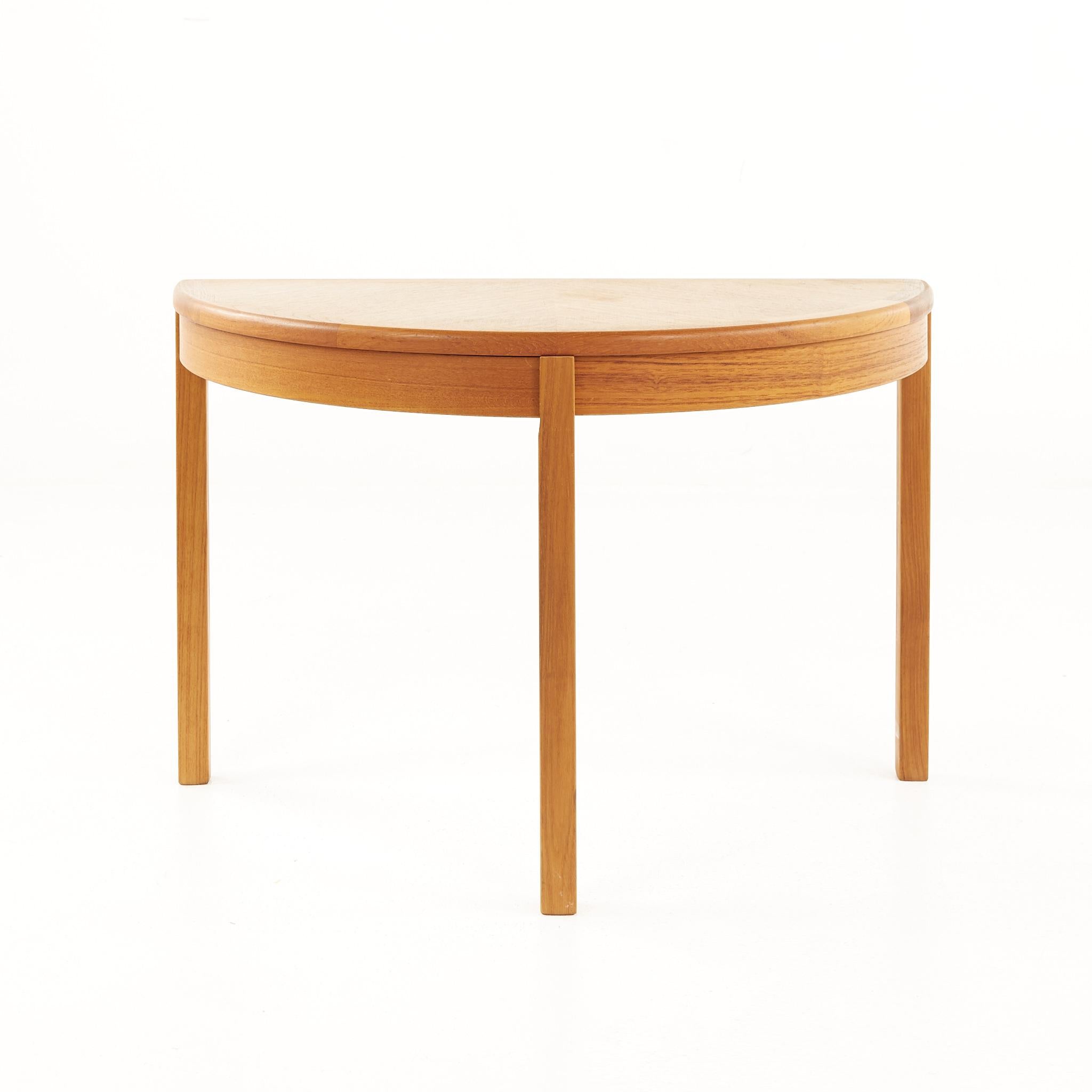 Mid century Danish teak half circle side table

This table measures: 29 wide x 15 deep x 19.5 inches high, with a chair clearance of 16.5 inches

All pieces of furniture can be had in what we call restored vintage condition. That means the piece