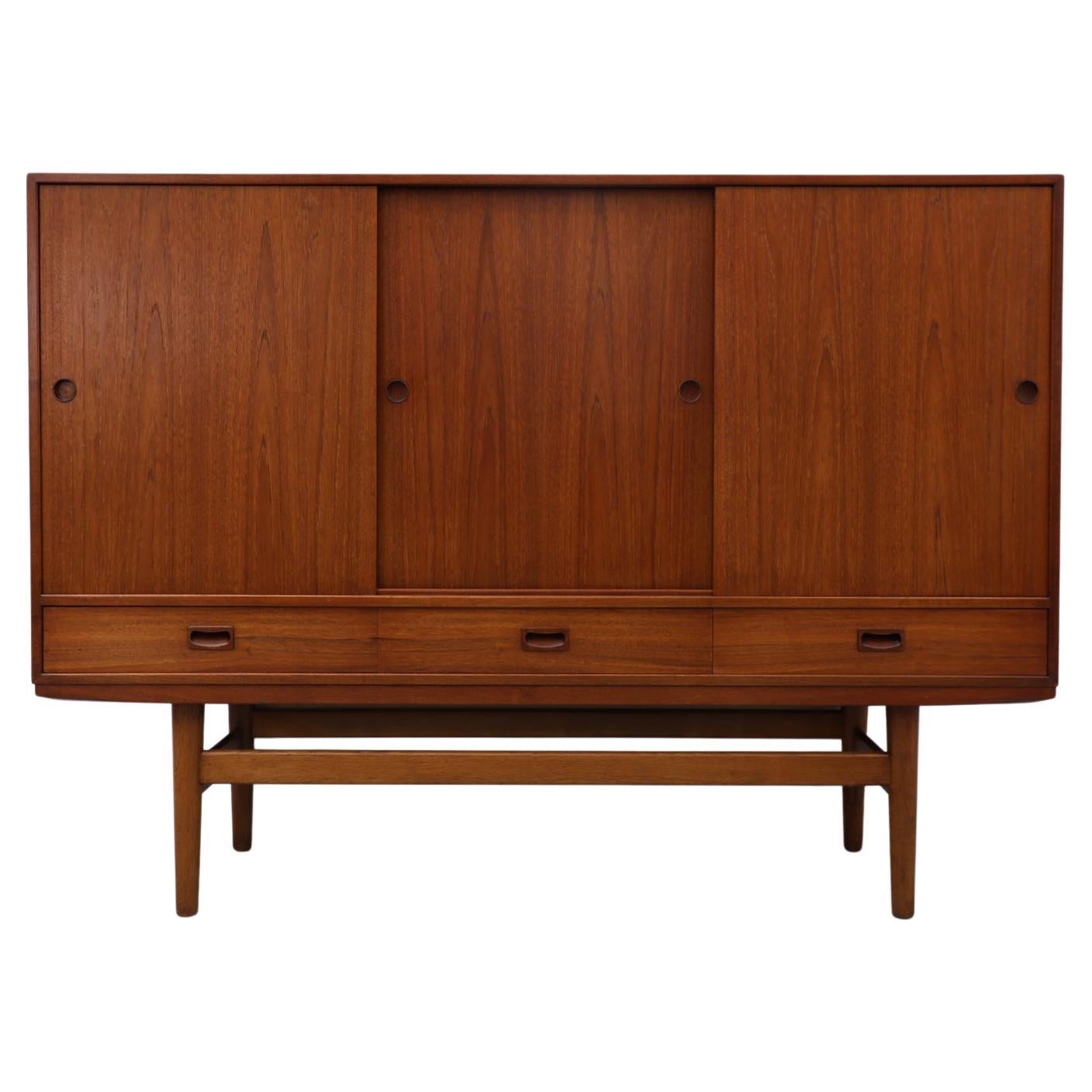 Mid-Century Danish Teak Highboard with Sliding Door Cabinets and Drawers For Sale