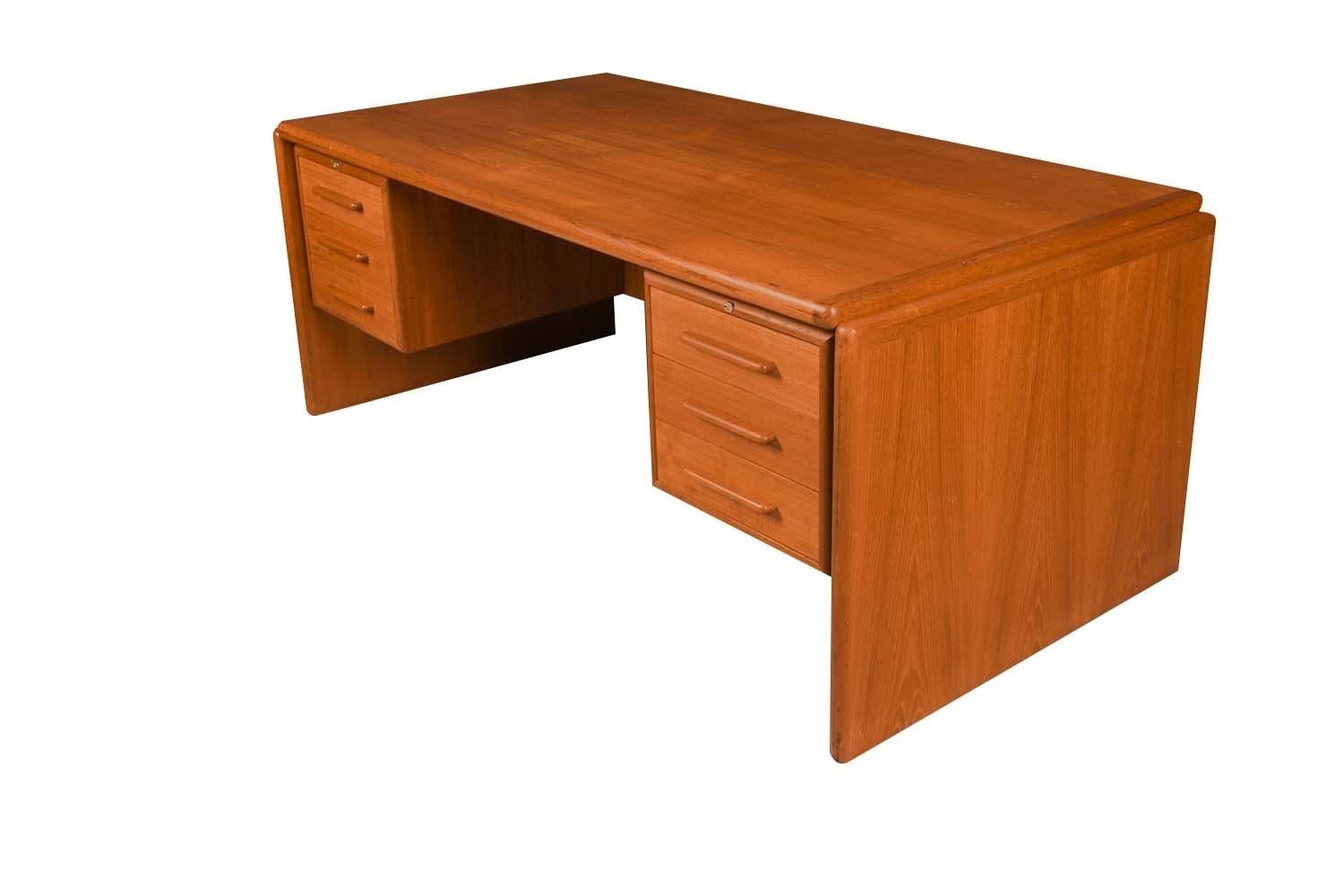 Large beautiful remarkable statement in design and craftsmanship. This large midcentury teak executive size desk, precisely crafted in exceptional teak grain wood, with a fully finished back the finished back side makes this desk ideal for placement