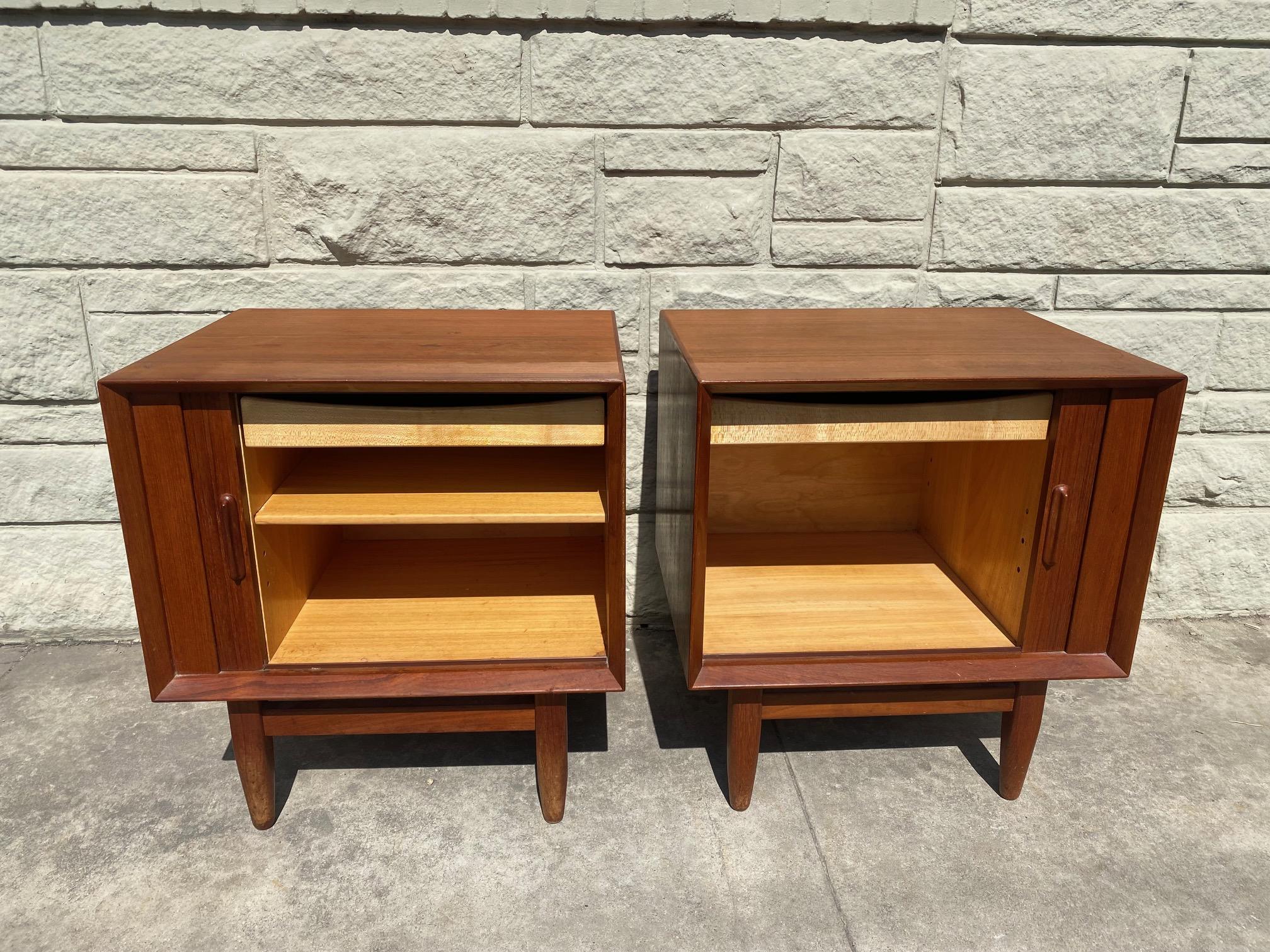 A set of vintage Danish nightstands with tambour doors made by Svend Madsen for Falster open up to plenty of storage with one drawer and an adjustable shelf. This pair of mid-century nightstands are in overall good condition. 

please note one