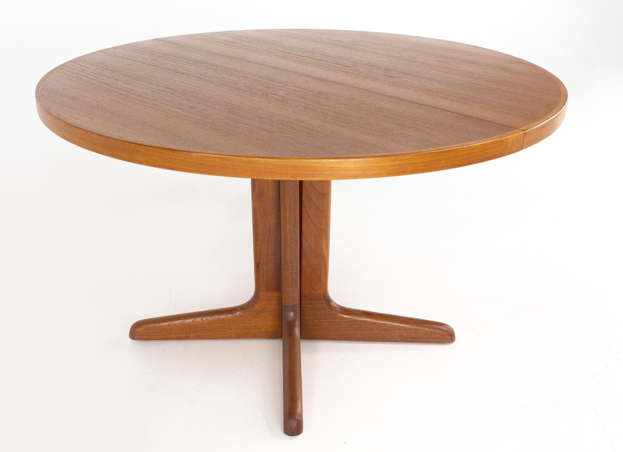 Mid Century Danish Teak pedestal base dining table with 2 Leaves

This table measures: 47.25 wide x 47.25 deep x 27.25 inches high, with a chair clearance of 25.5 inches, each of the 2 leaves are 20 inches wide, making a maximum table width of