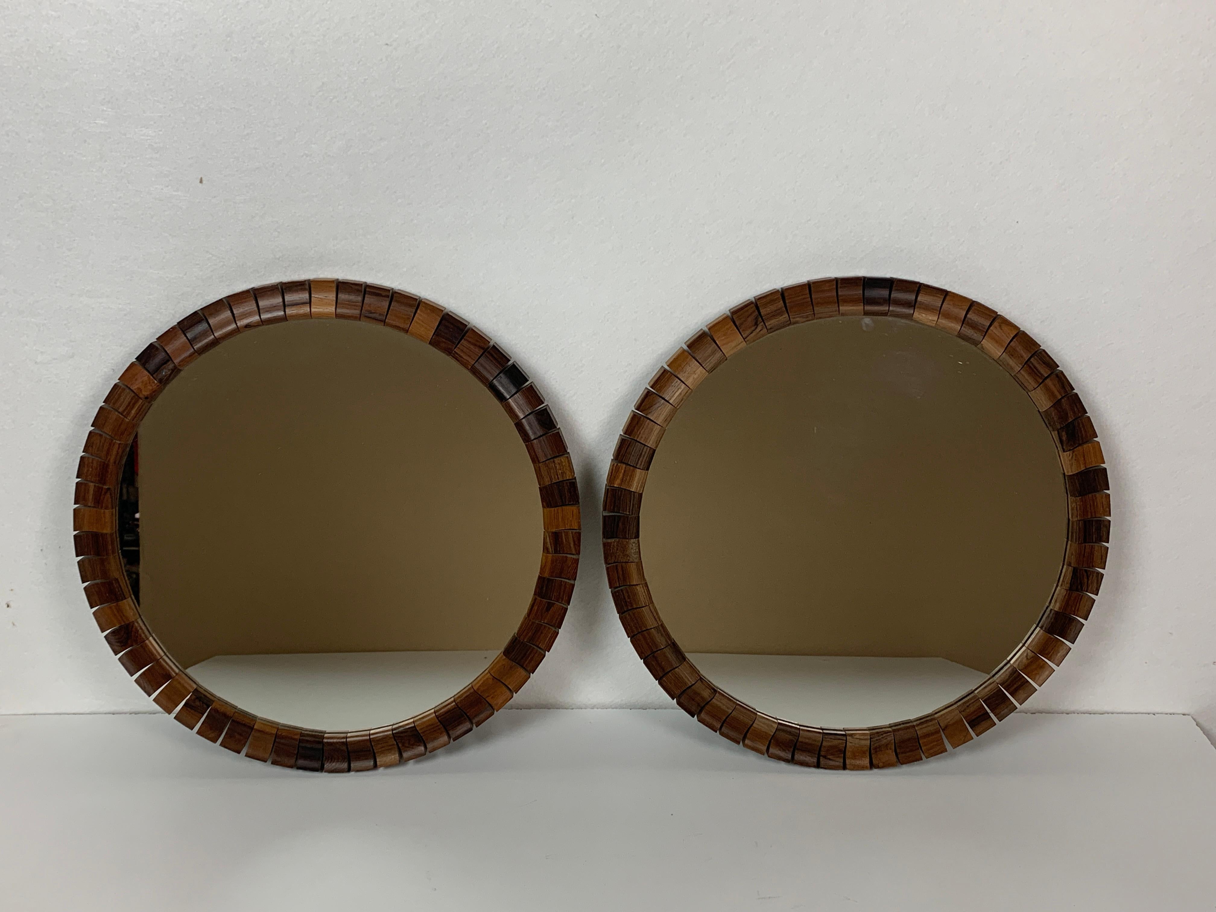 Gorgeous pair of Danish mirrors in coromandel teak cubes, 1960s. This pair is in great vintage condition considering their age with no real flaws to mention. A perfect addition to ones bathroom for example.