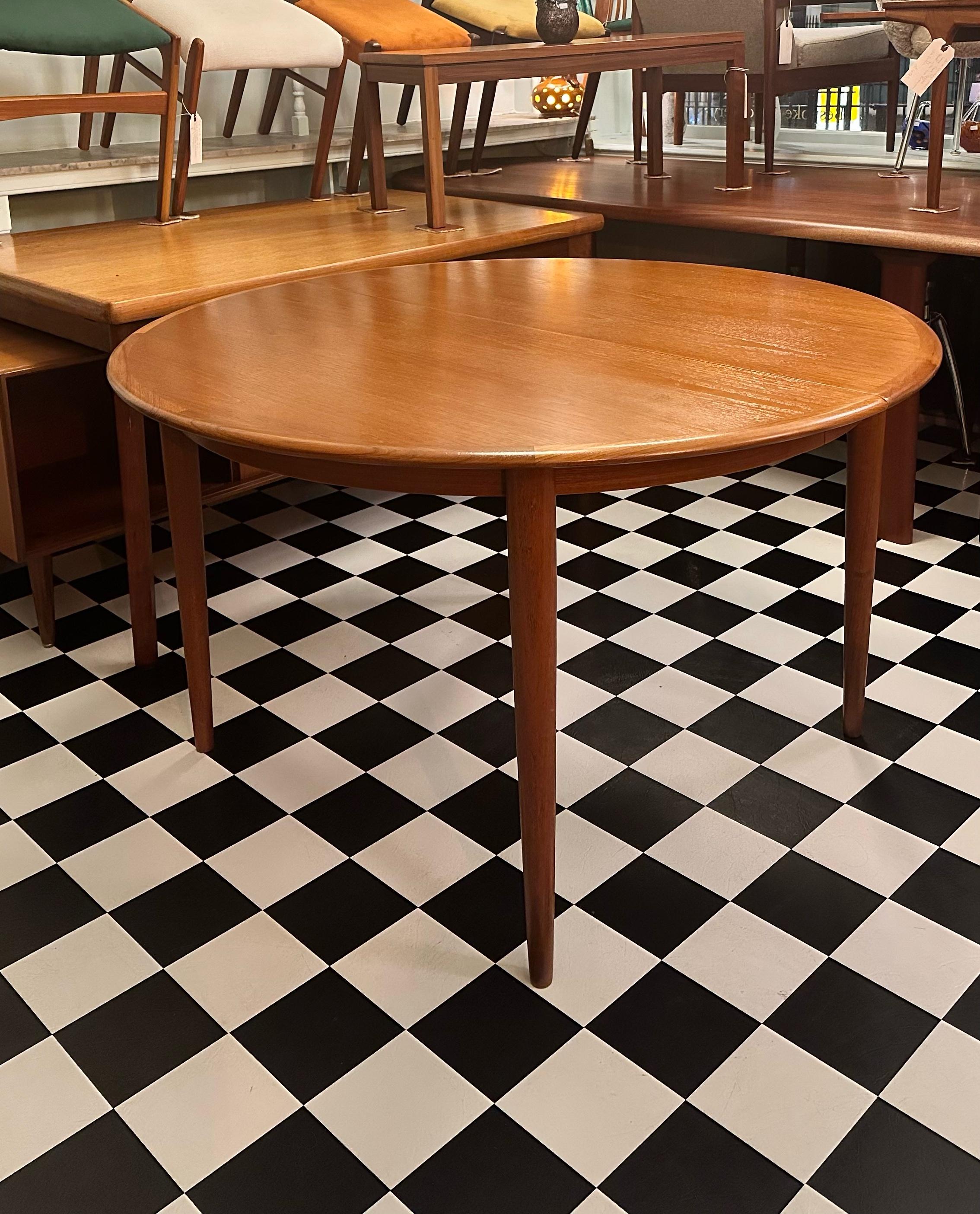 
Beautiful mid-century modern Danish teak round extendable dining table. Designed in 1960's by Skovmand & Andersen for Farstrup Møbler. Having two separate extensions, this table is very versatile. It is comprised of very stylish legs (which can be
