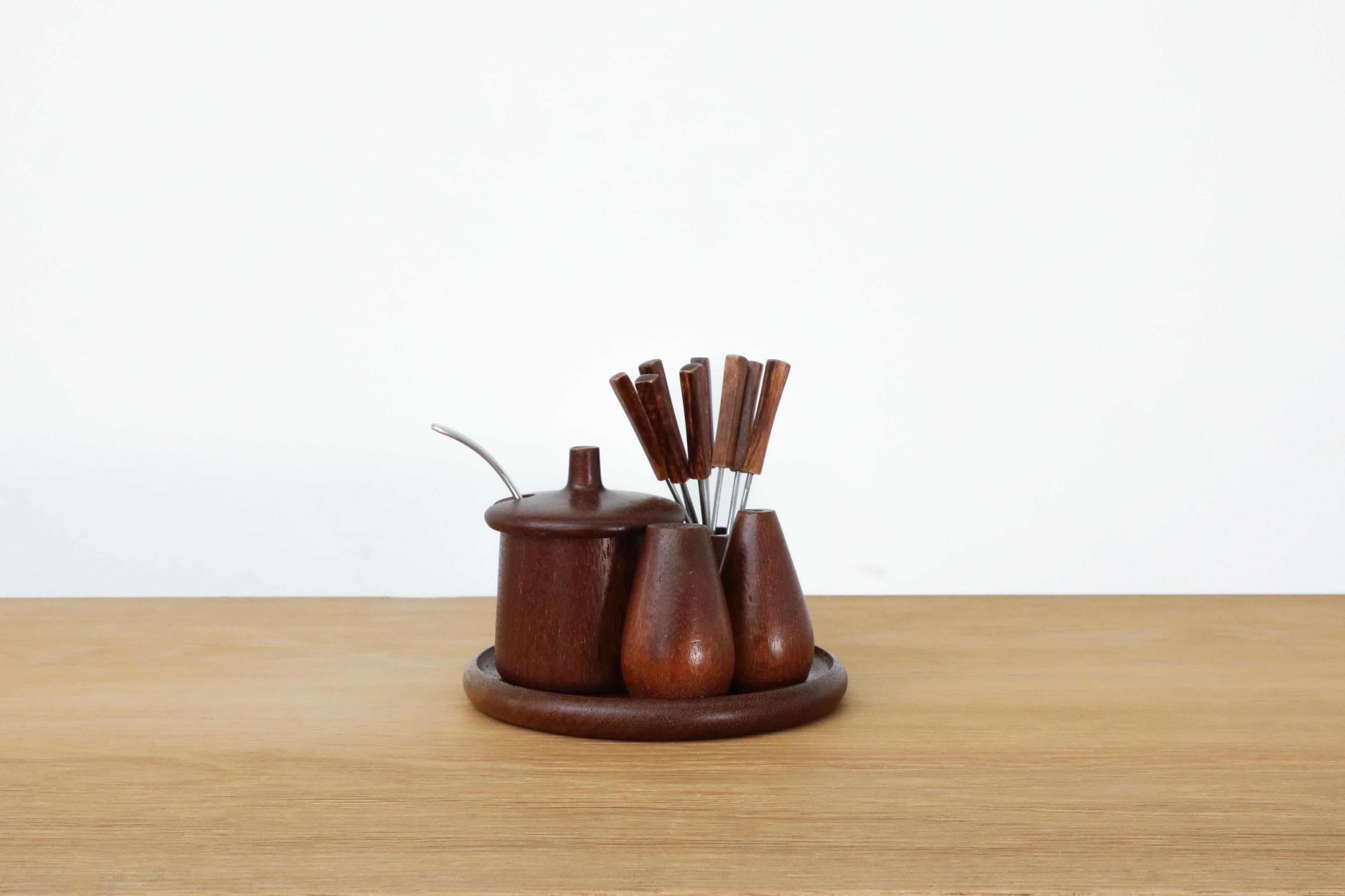Danish teak breakfast set with jelly pot, plate, salt and pepper shakers and fondue skewers. In original condition with visible wear consistent with its age and use.