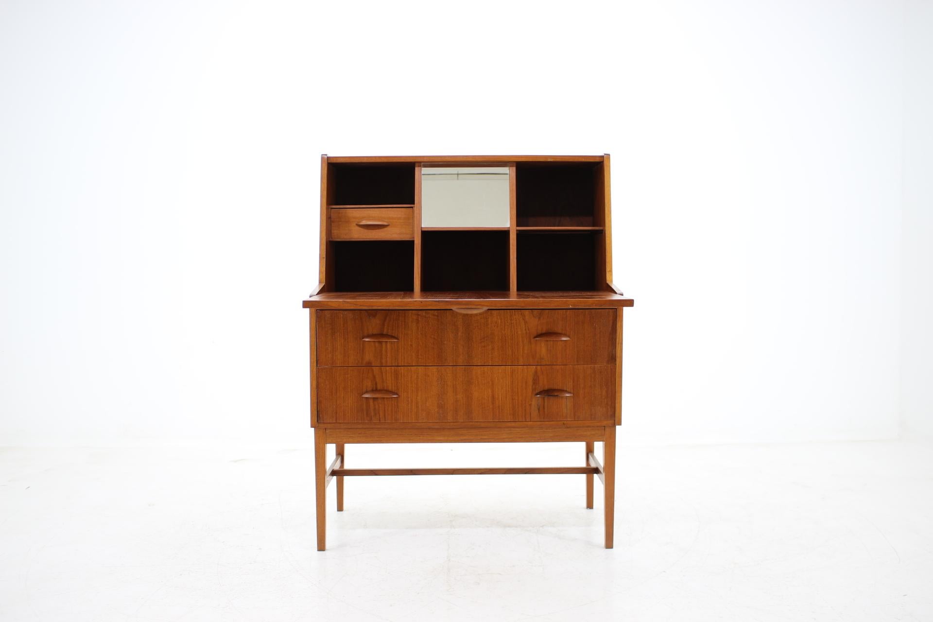 This Danish teak writing cabinet features two drawers and one compartment with writing area. The extendable writing area desk can be extended up to 69 cm. This item was carefully refurbished.