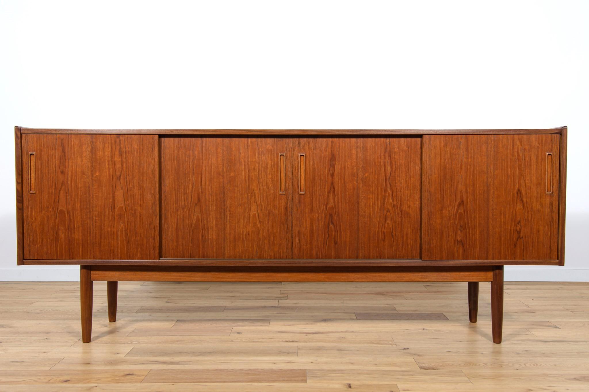 
Sideboard made in the 1960s in Denmark. Sideboard consists of four sliding doors, inside there are shelves and two drawers. The chest of drawers has profiled teak handles. The sideboard is after a comprehensive carpentry renovation. It has been
