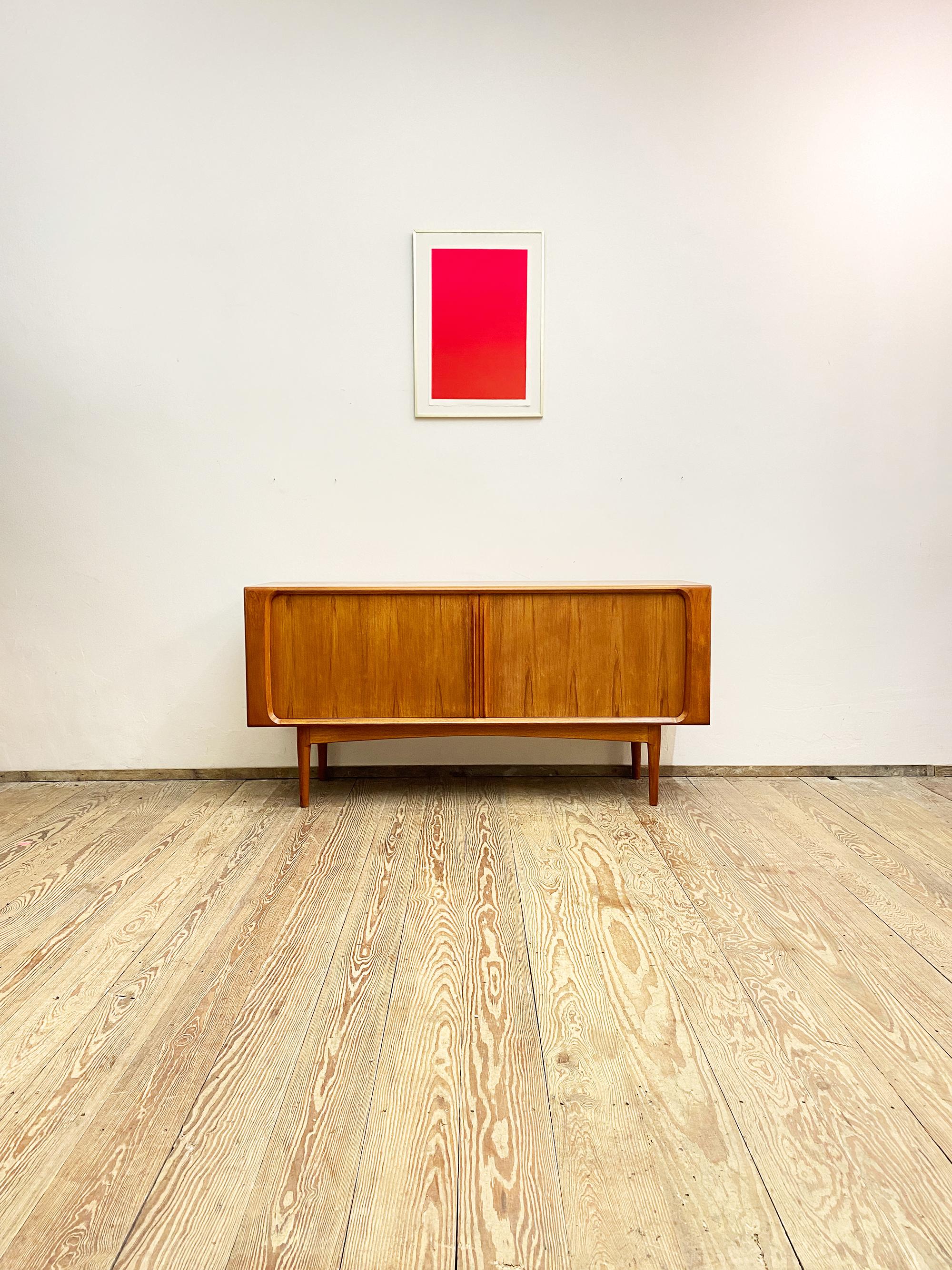 Dimensions: 160x50x80 cm (width x depth x height)

This beautiful sideboard was designed by Bernhard Pedersen in the 60s in Denmark. The sideboard comes with tambour door that slide to the sides and hide two big compartments with shelfs and three