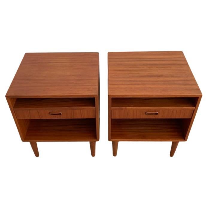 Teak mid century Danish nightstands. Made in Denmark by Arne Vodder for Falster. Each nightstand has a single drawer and cubby above and below. Solid teak peg legs. Sold as a pair of nightstands (2). Made in Denmark. Located in Brooklyn NYC.

Each