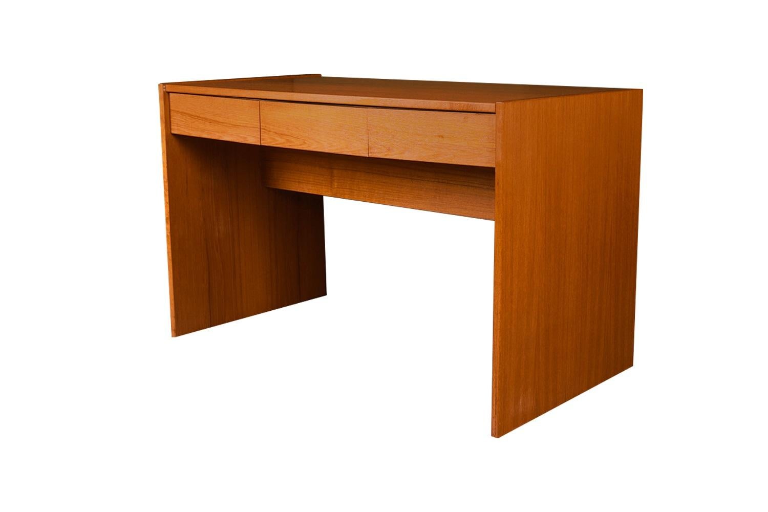 A desk with incredible form and presence. This attractive original Danish Modern desk by Nordisk Andels-Eksport made in Denmark, features a rectangle frame with sliding top surface above three drawers. This movable top glides smoothly from back to