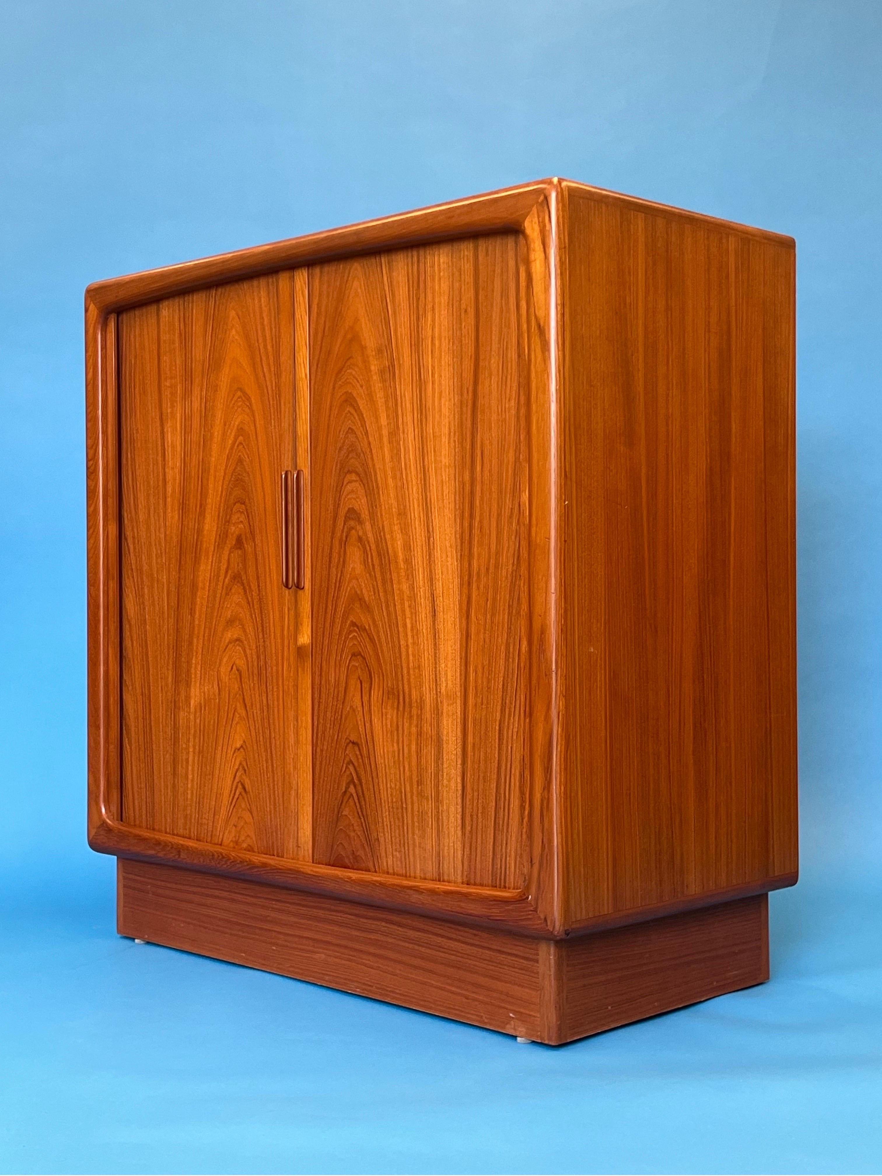 Danish teak tambour door console by HP Hansen. Two pull pullout trays for bar ware or record/ media. So much space for so many different options. Cord cut outs in back and the tambour doors open smooth and conceal all your goods while showing off