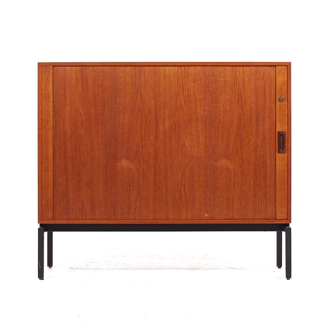 Mid Century Danish Teak Tambour Door Credenza

This credenza measures: 43.25 wide x 15.75 deep x 37.25 inches high

All pieces of furniture can be had in what we call restored vintage condition. That means the piece is restored upon purchase so it’s