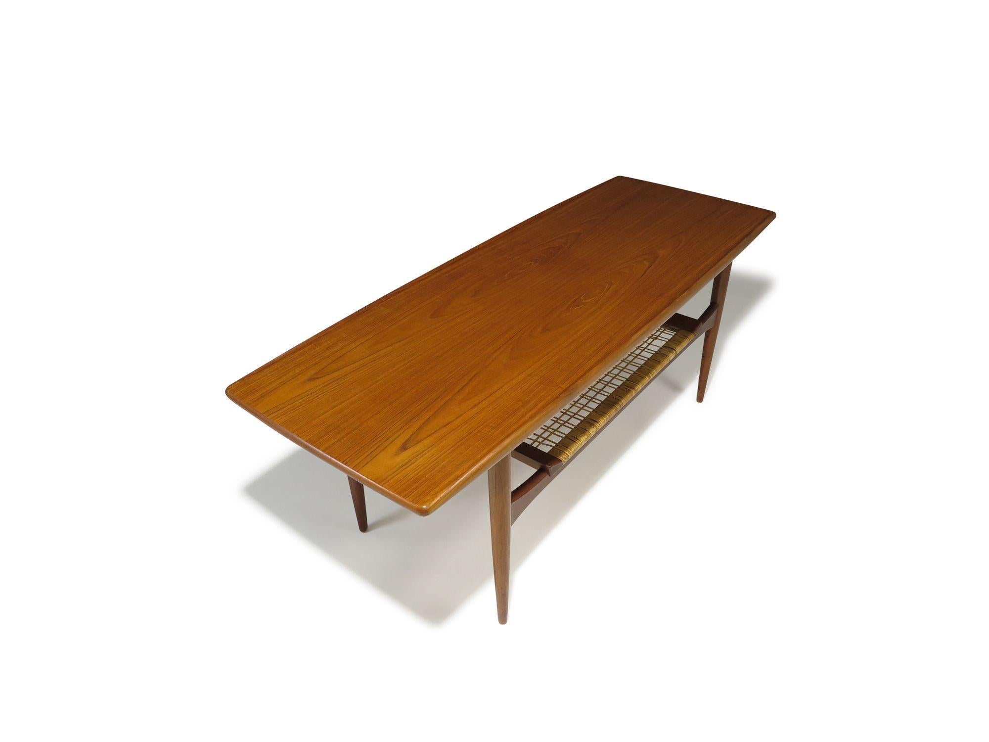 Mid-Century Danish Teak Two-Tier Coffee Table with Sculpted Edges & Caned Shelf For Sale 1
