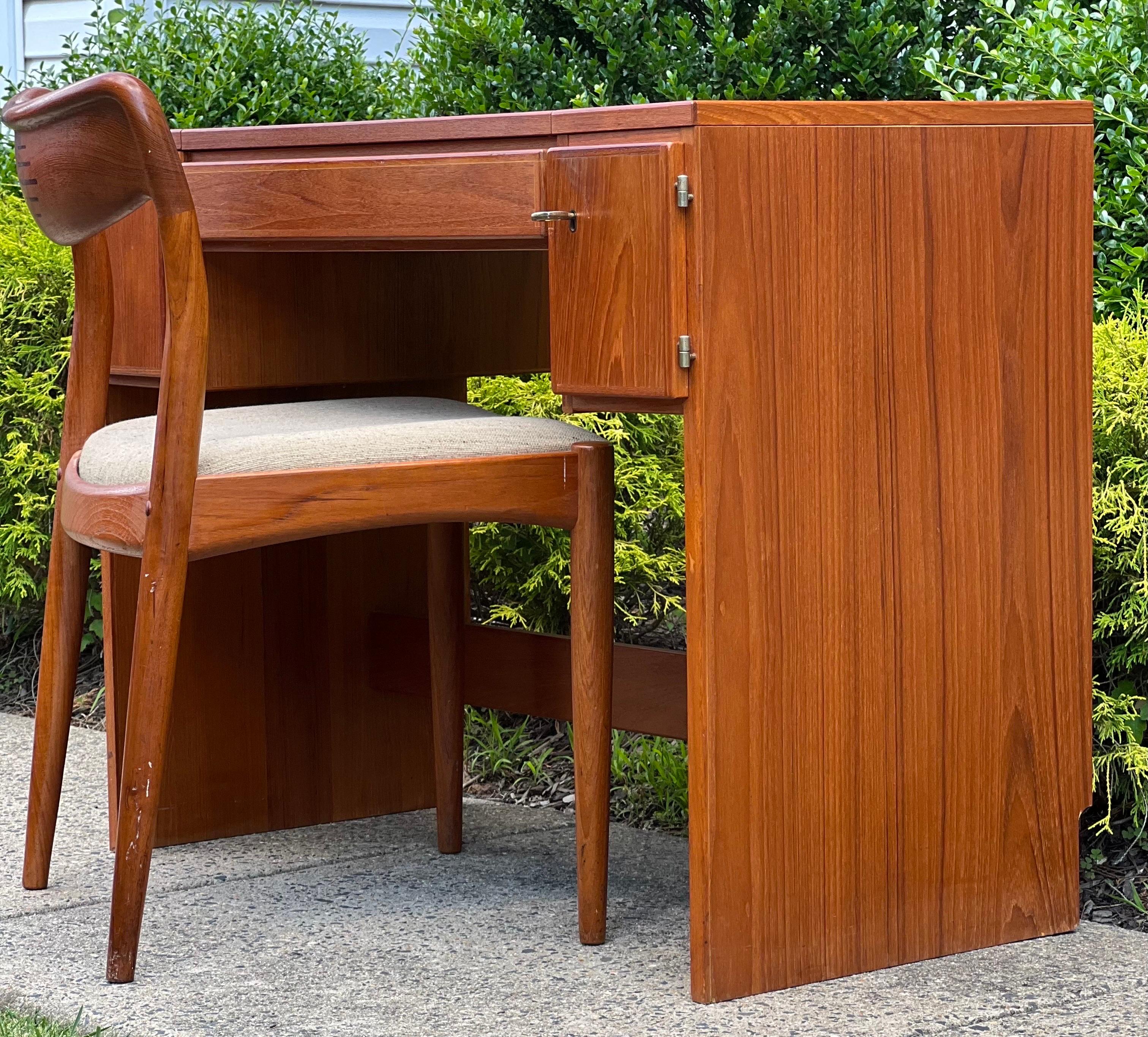 Fabulous 1960's Danish teak vanity with flip open top and coordinating upholstered chair by Uldum Mobelfabrik, made in Denmark.

Beautifully crafted, this vanity offers three intelligently designed sections and features a flip open top with a high