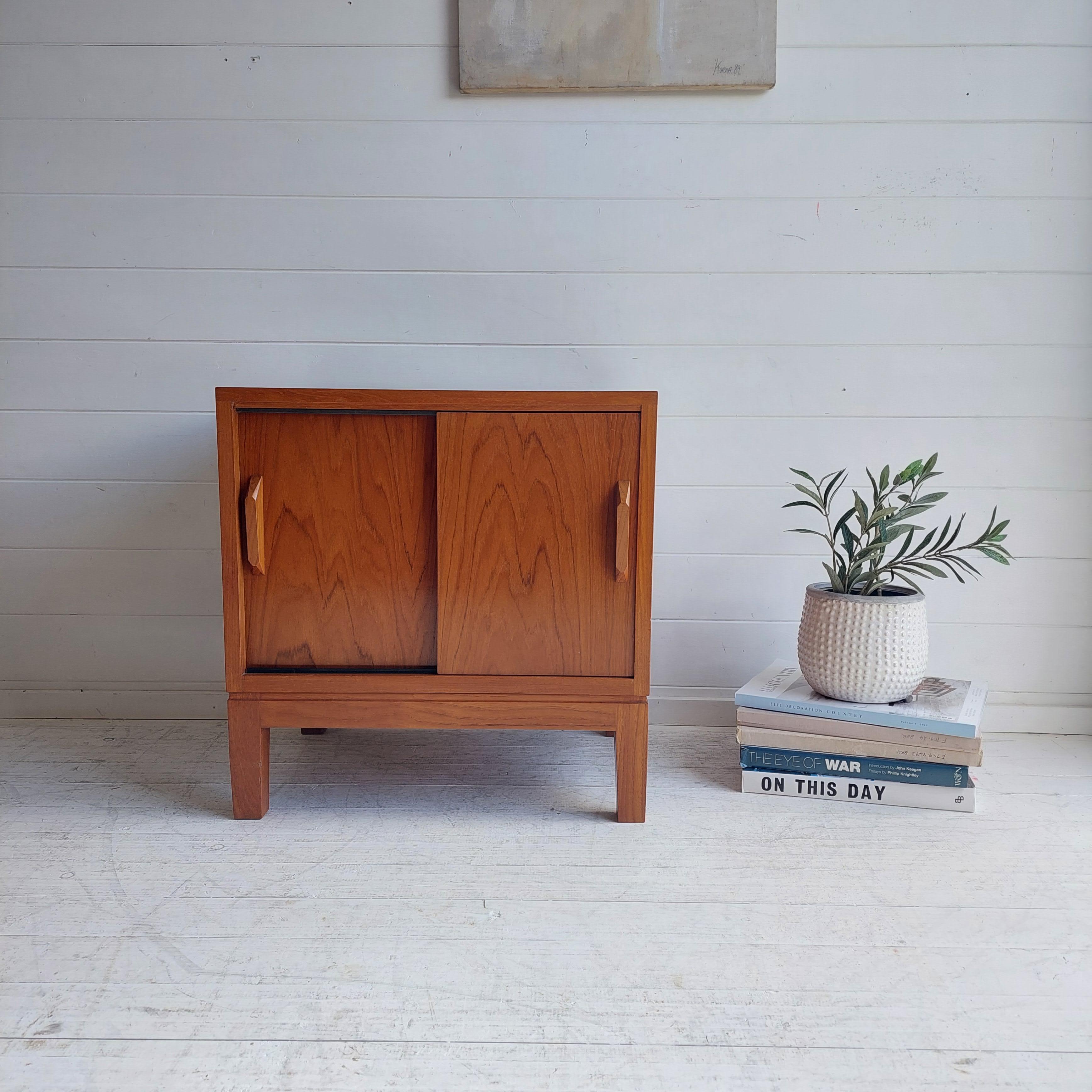 A beautifully designed & crafted, Danish style sliding door media cabinet.
A smart and stylish vintage record cabinet in teak, this dates from the 1970's. 

Featuring minimal clean lines and sliding doors with dividers, making the cabinet ideal for