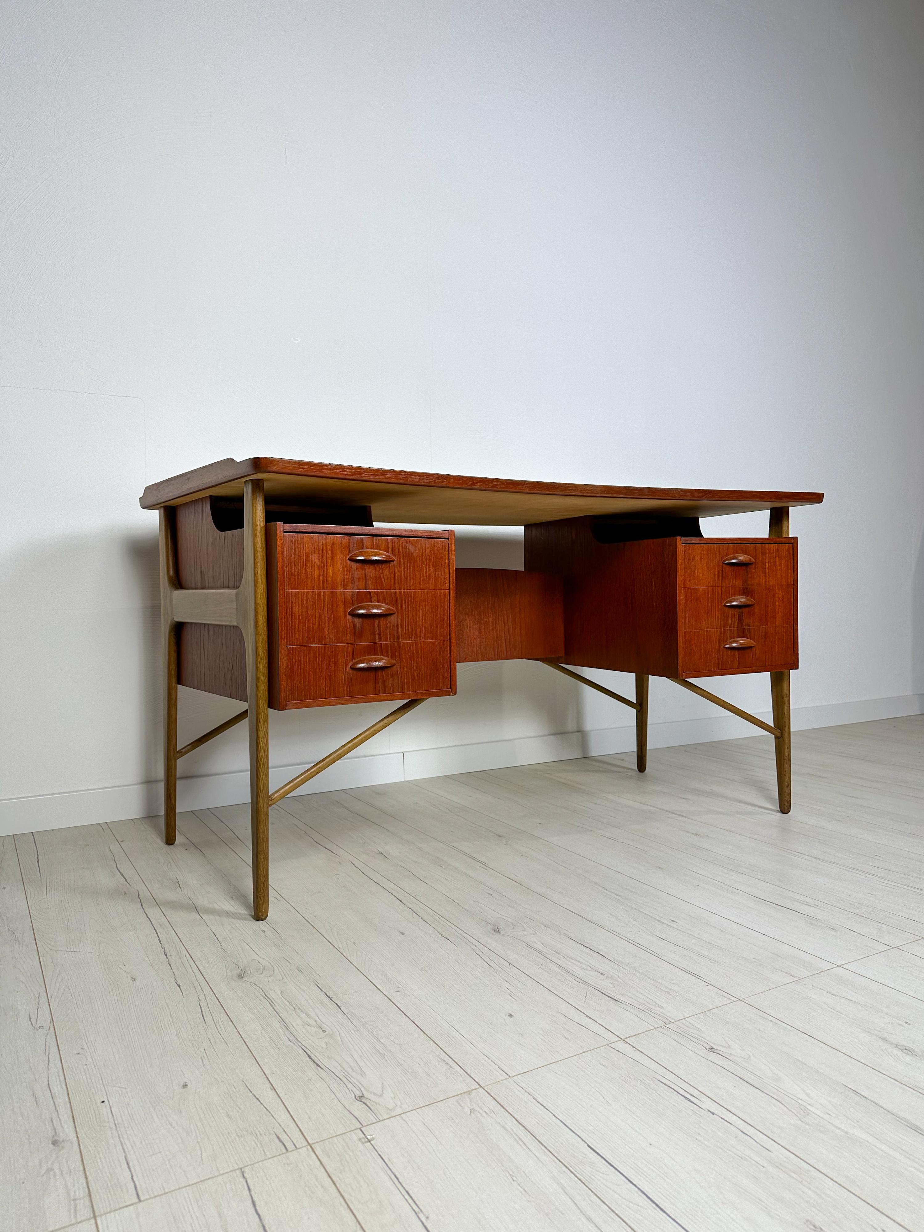 Beautiful vintage bow-fronted writing desk original from the 1960s featuring six drawers with backside shelving for additional storage space and a minibar. Walnut legs combined with high-quality teak wood. Designed by Svend Aage Madsen. Denmark.